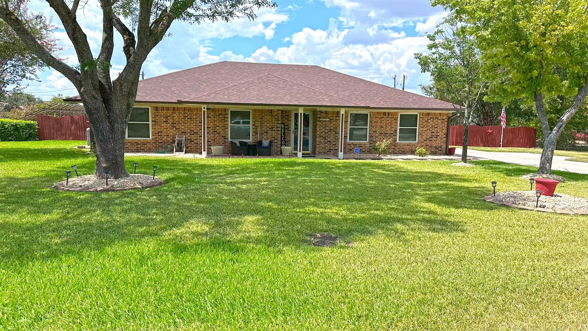 Classic brick exterior sits behind a sprawling gr