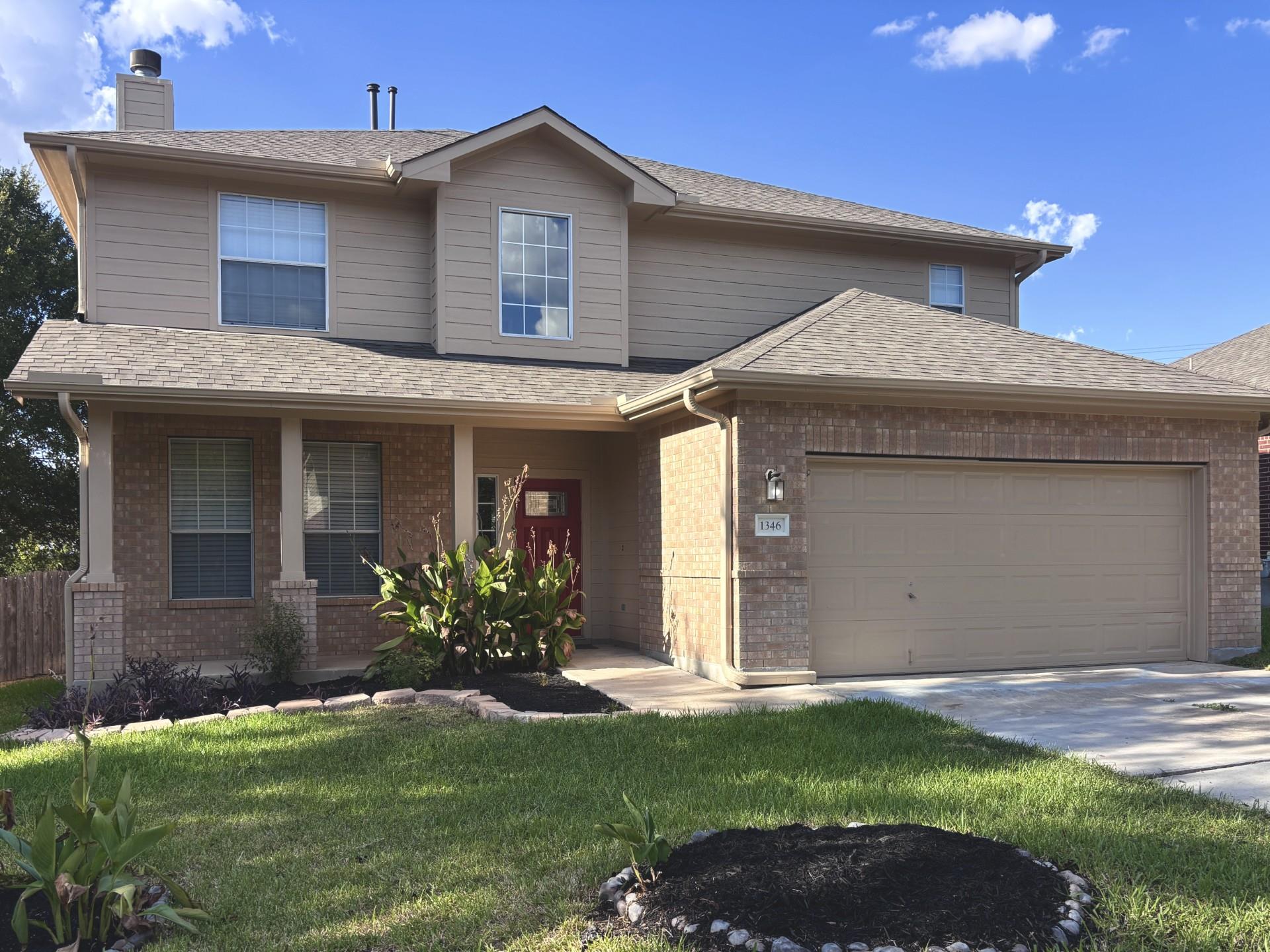 Classic brick and siding accents define the exter