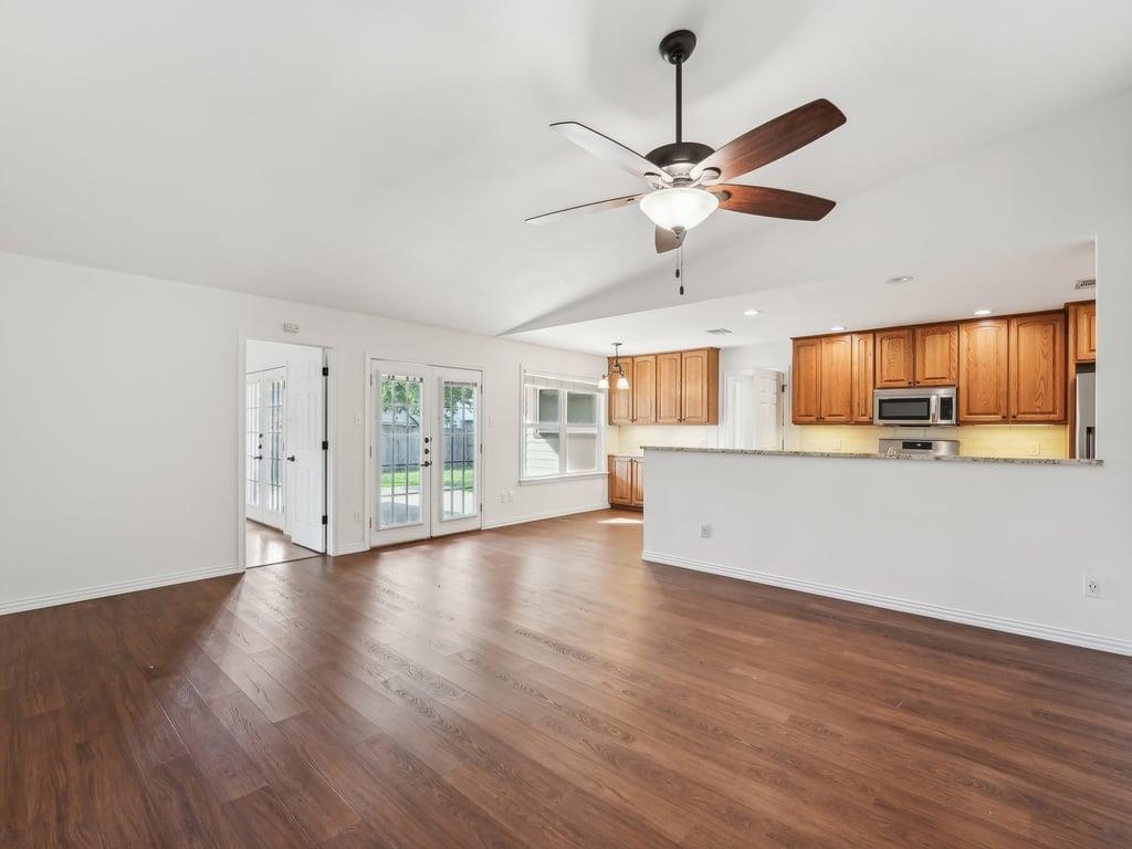 Unfurnished living room featuring dark wood-type 