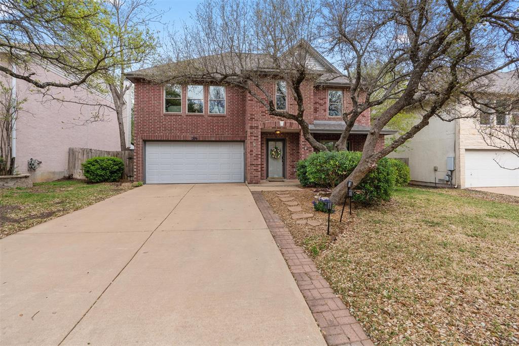 Stately brick exterior features a wide concrete d