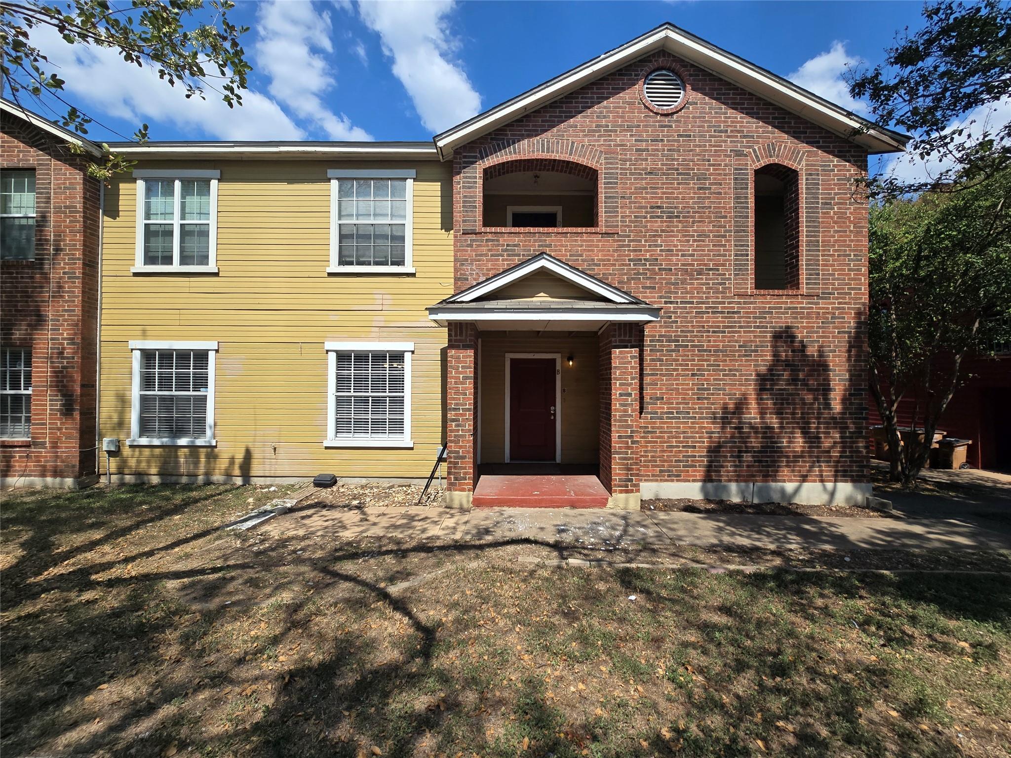View of front of house featuring brick siding and