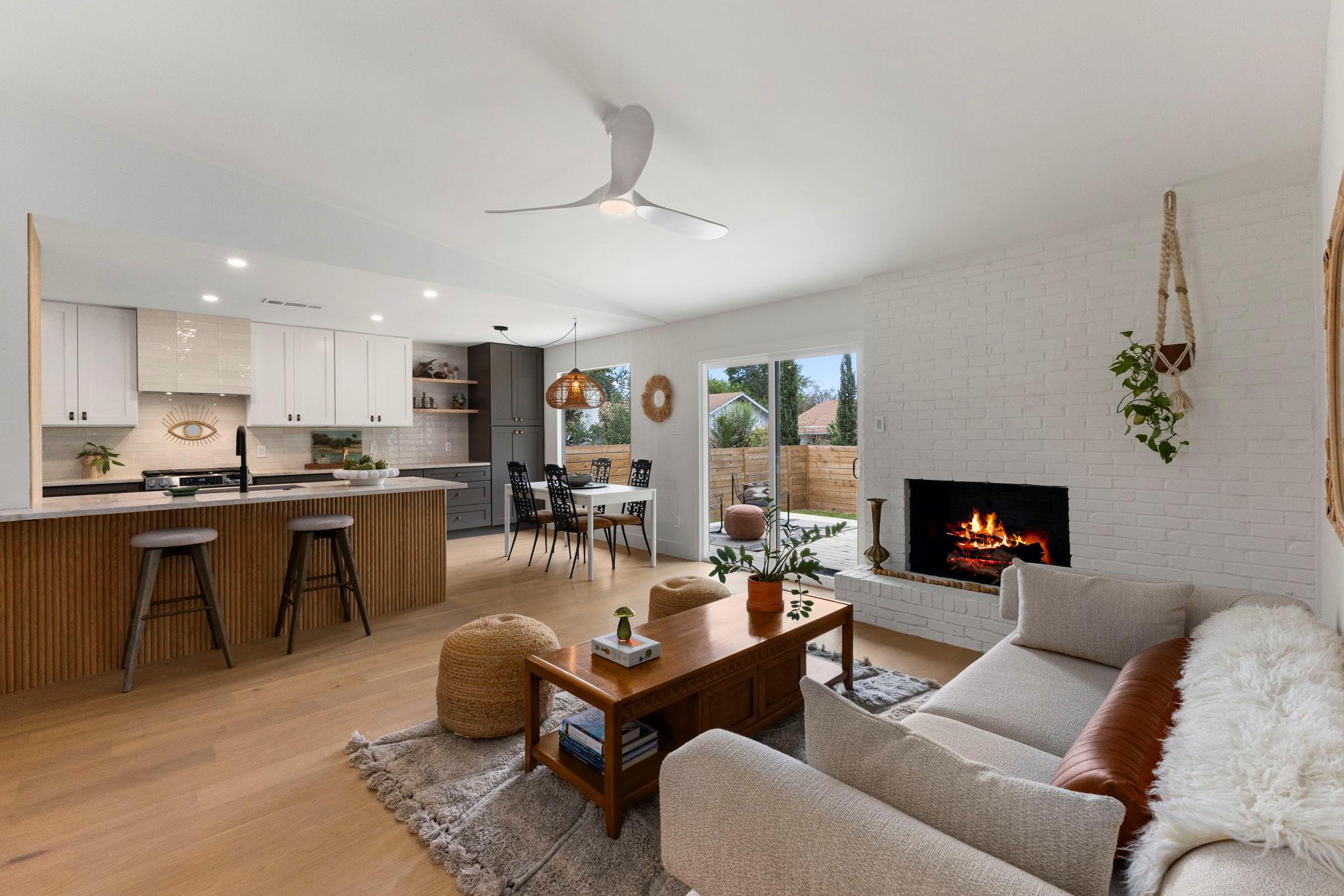Warm wood floors and a painted brick fireplace an