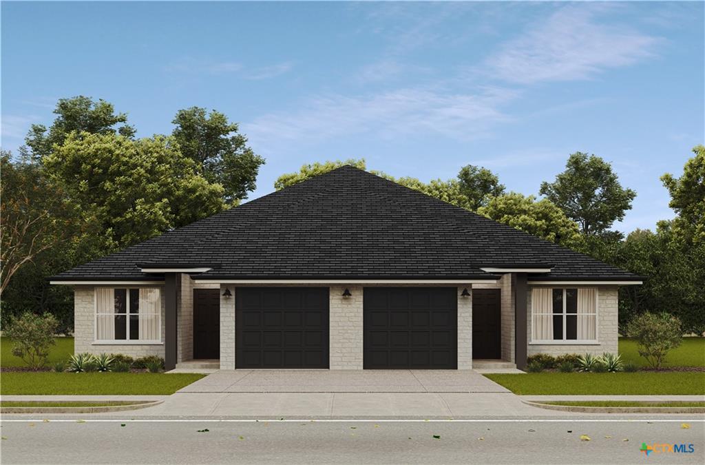 A symmetrical stone exterior features dual drivew