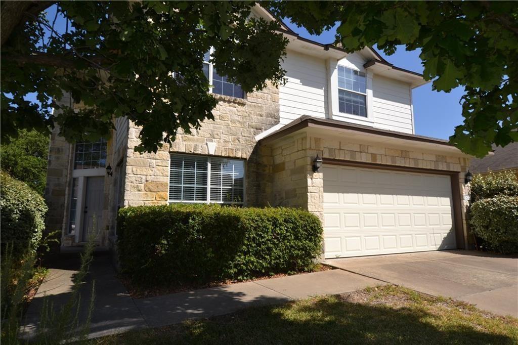 Limestone masonry accents the exterior of this tw