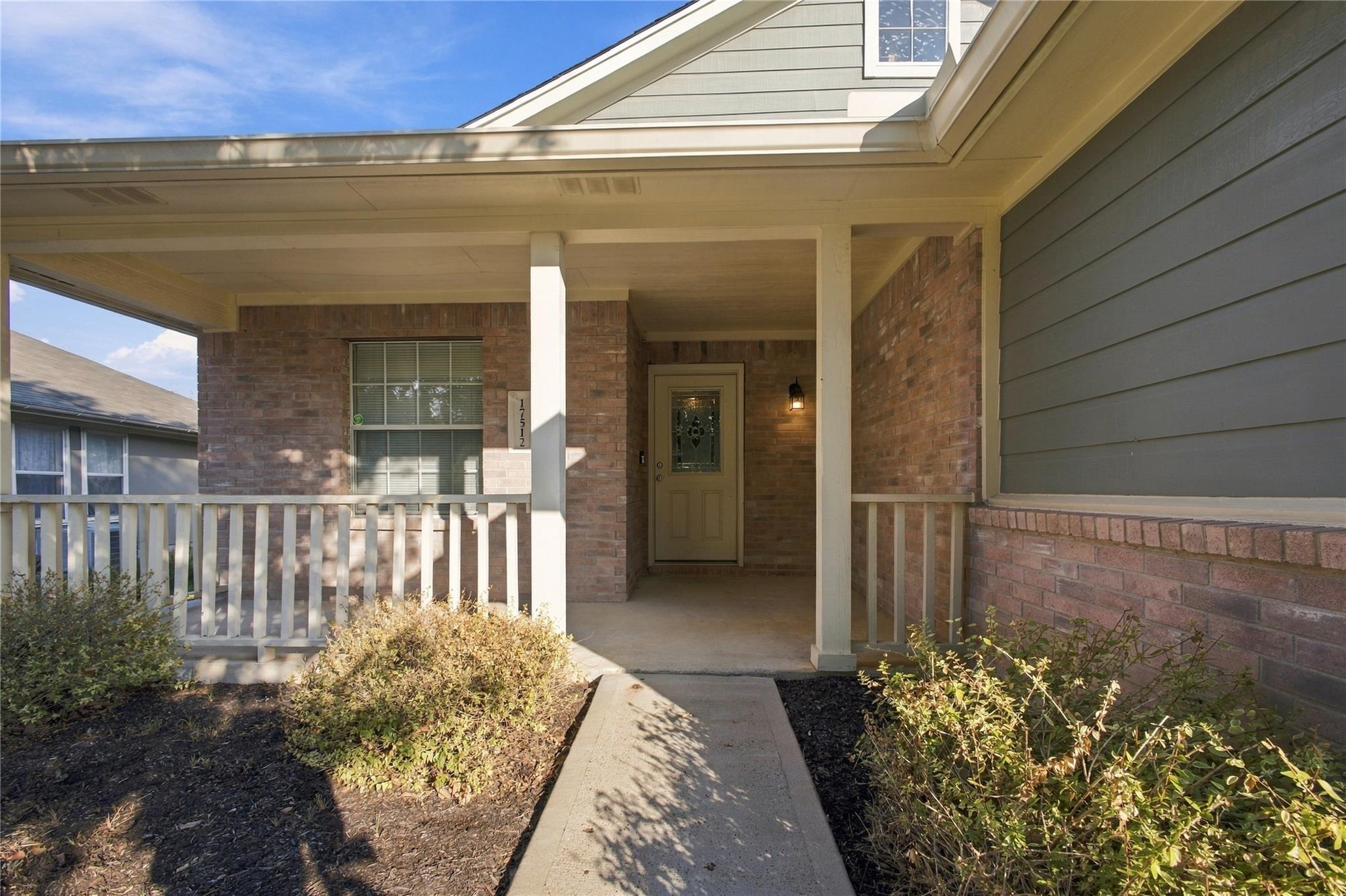 A welcoming front porch with classic brick detail