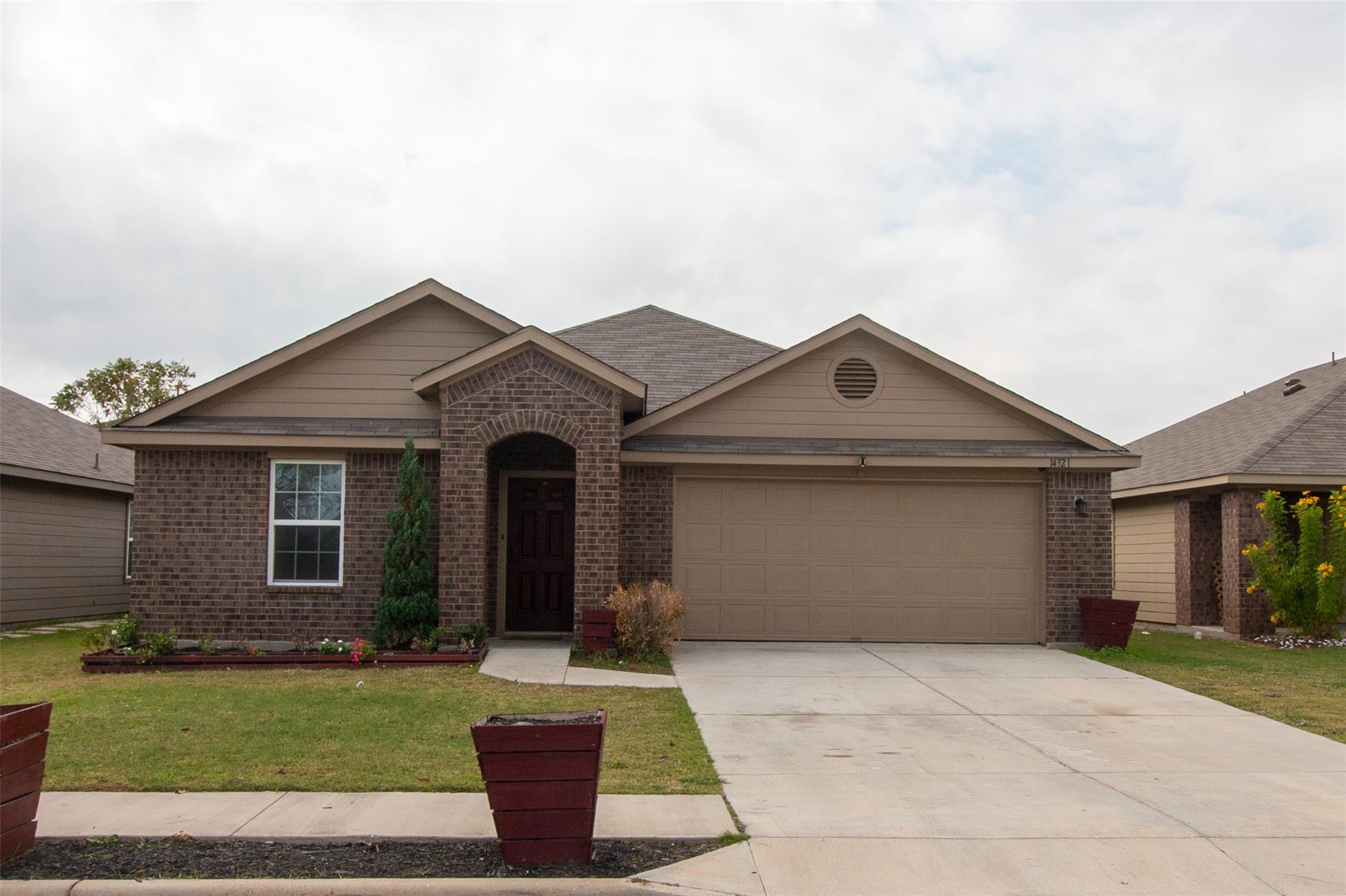 Brick detailing and a multi-gable roofline define