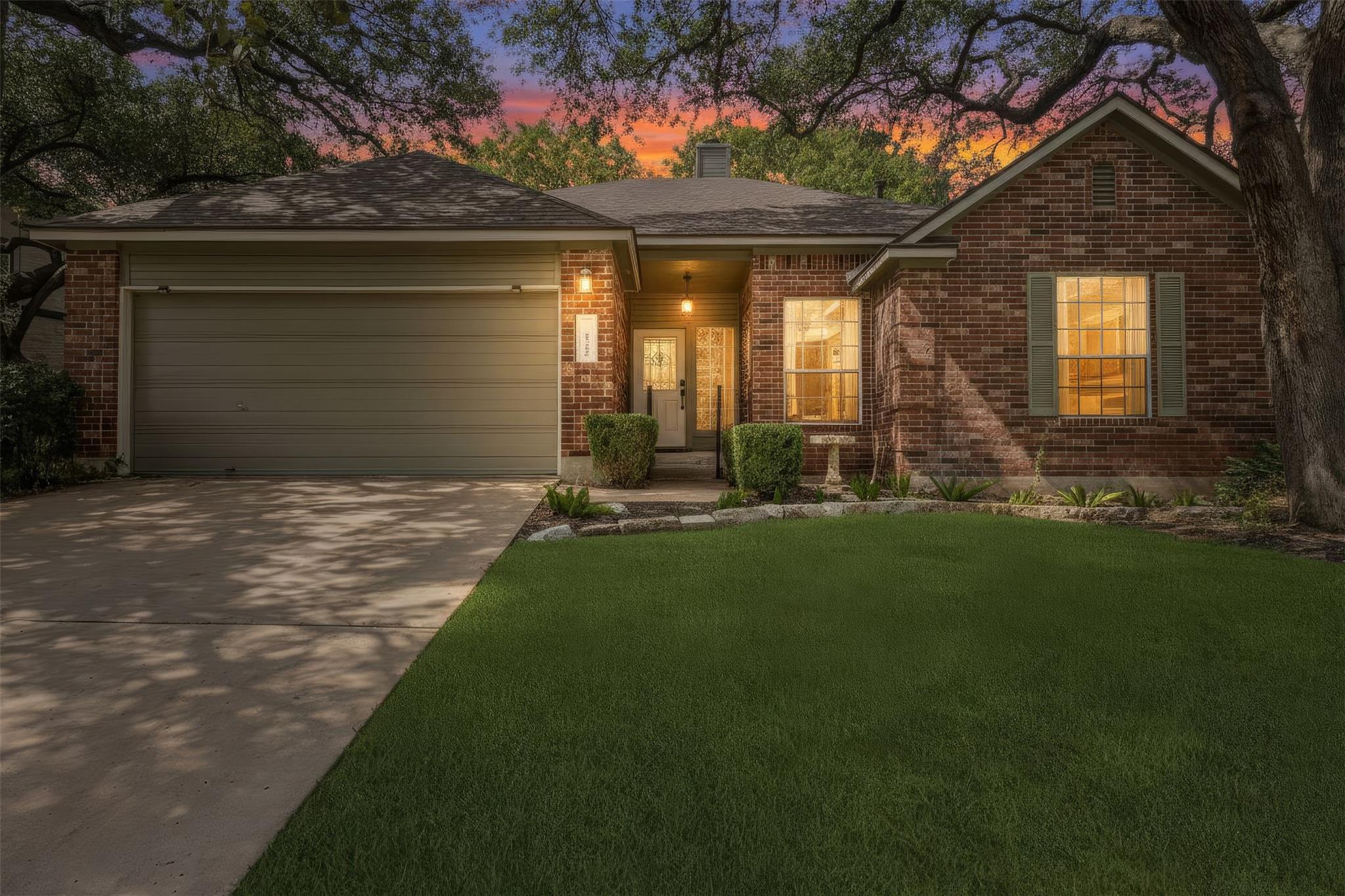Mature trees shade a classic brick exterior compl