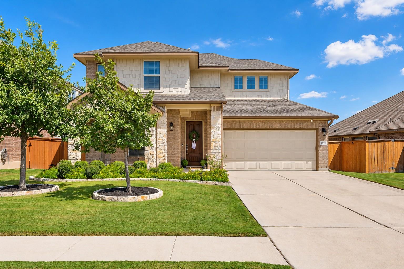 An inviting stone and siding exterior welcomes yo