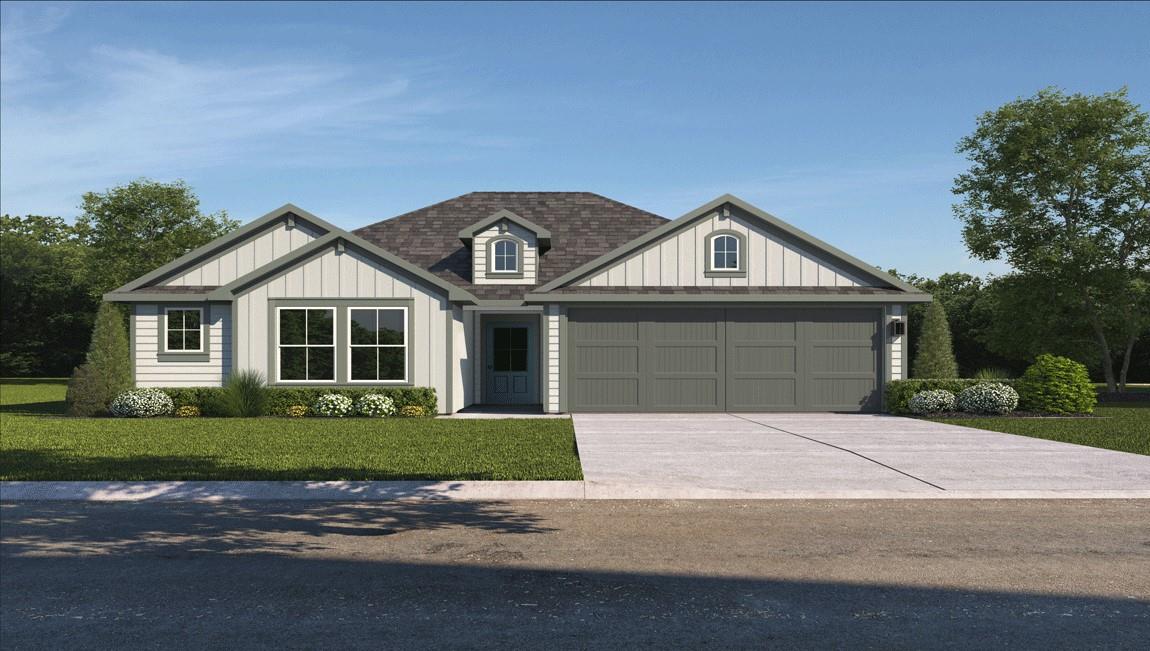 A welcoming facade with a dual garage and well-ma