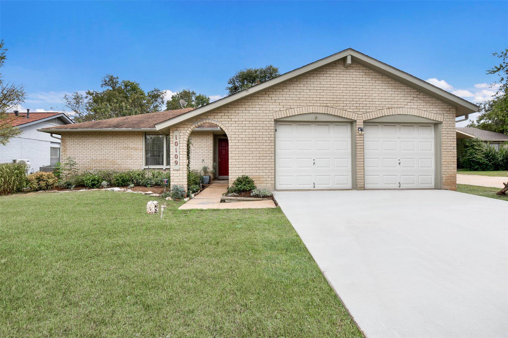 Classic brick elevation pairs with a wide concret