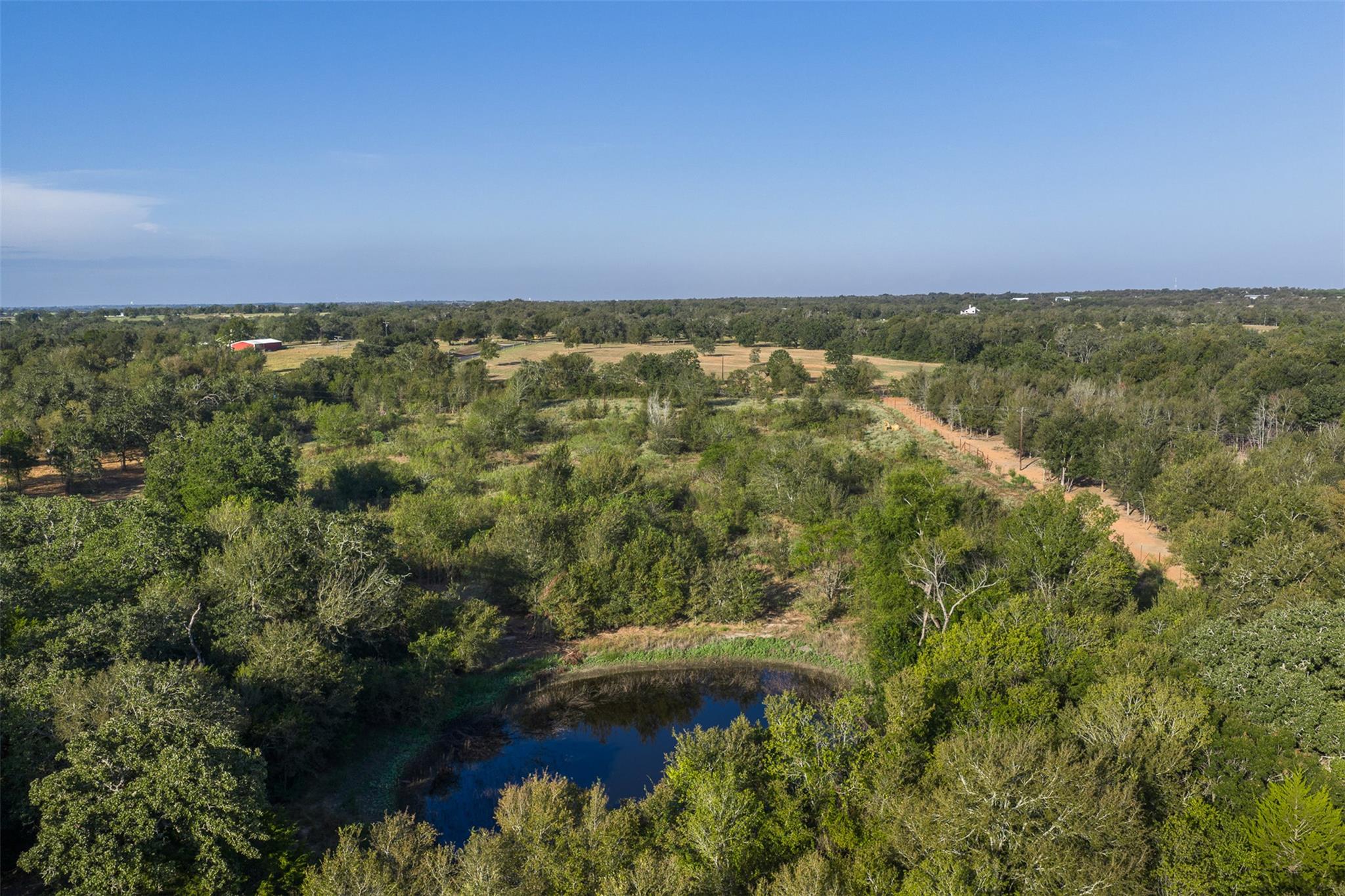 Mature trees and a quiet pond define this expansi