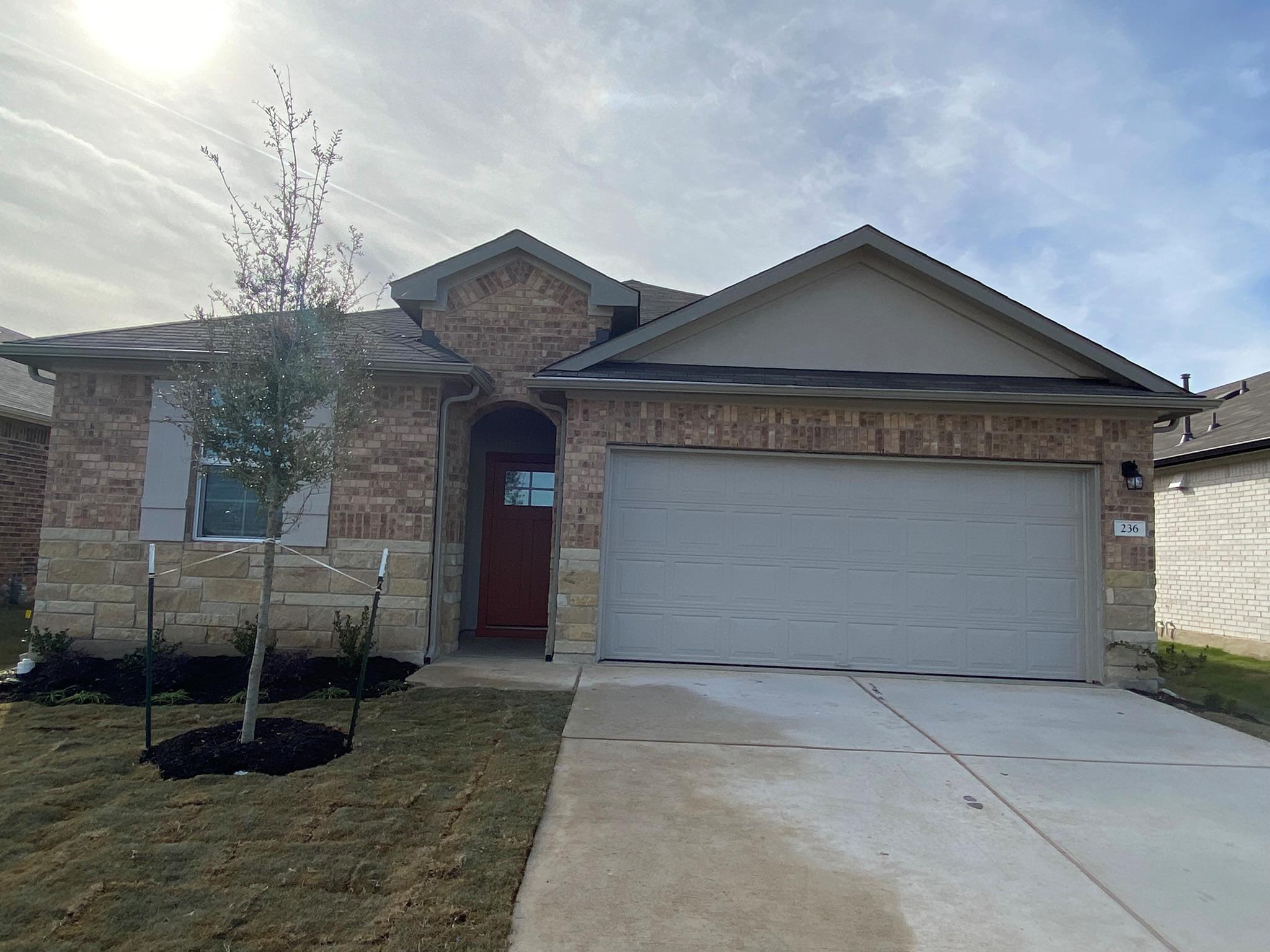A classic brick exterior and a concrete driveway 