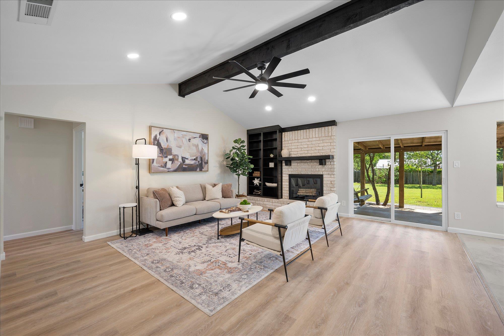 Rich wood floors and a vaulted, beamed ceiling hi