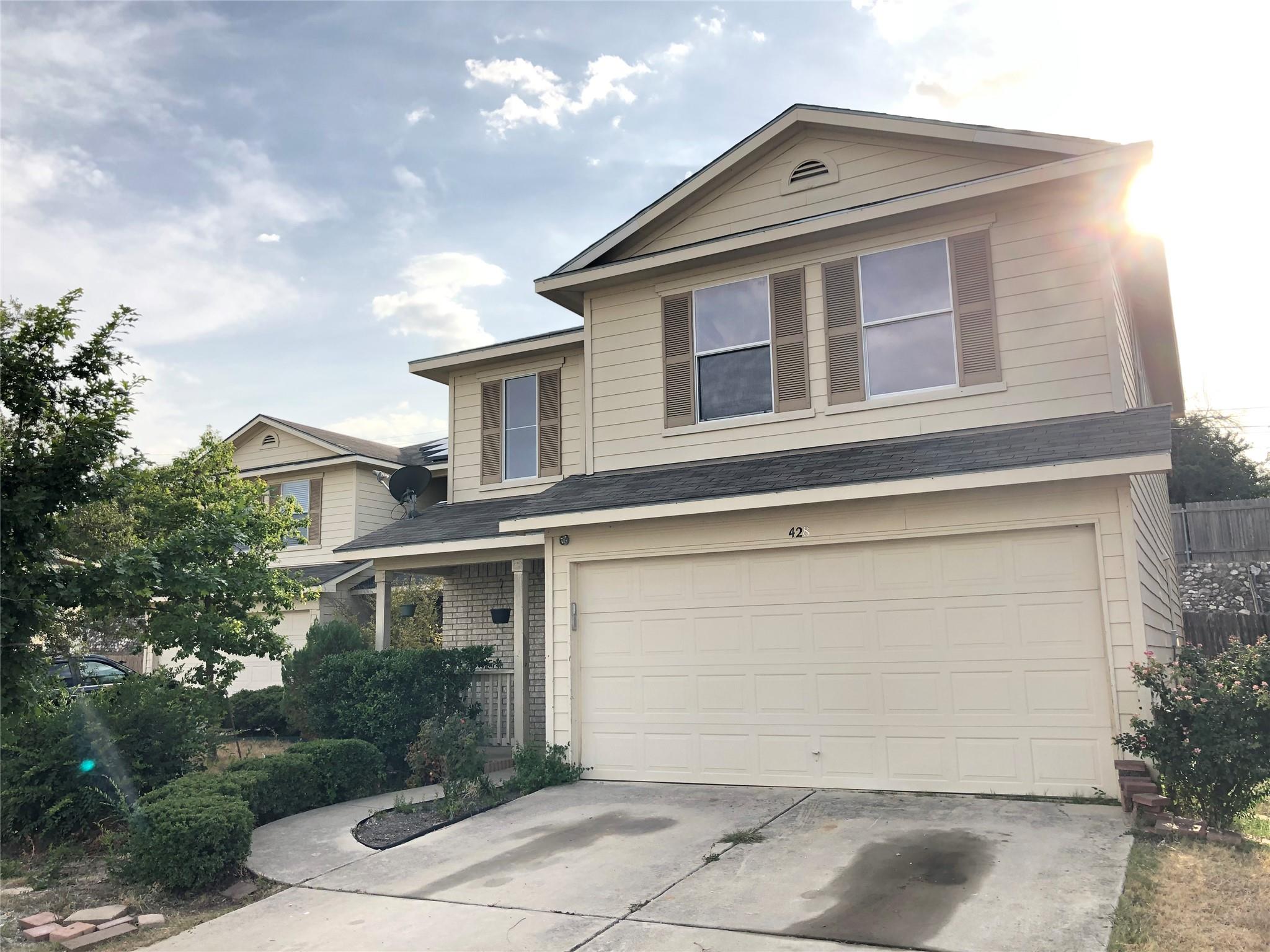 Classic siding and brick accents define this two-
