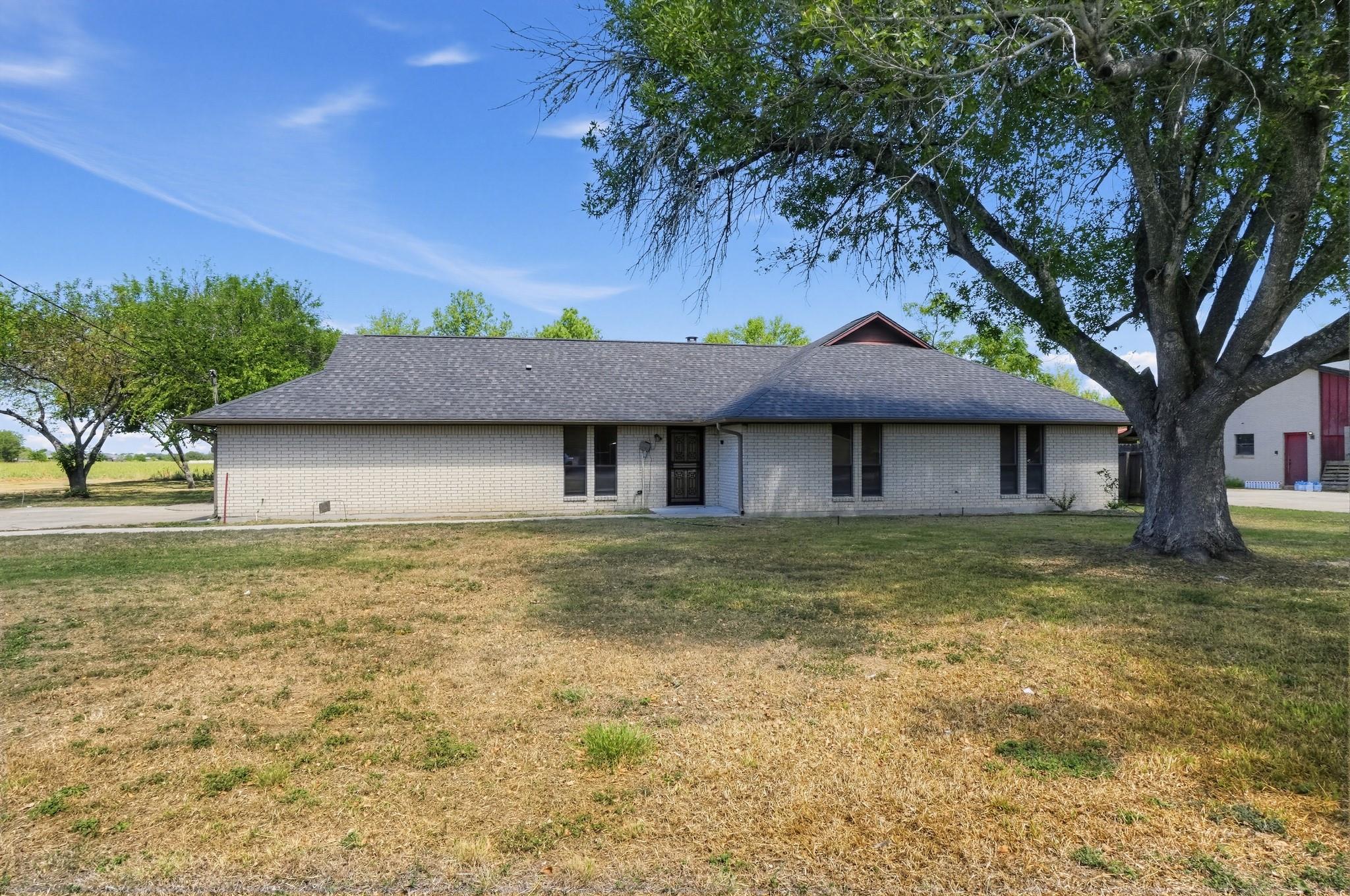 Classic brick exterior and mature trees define th