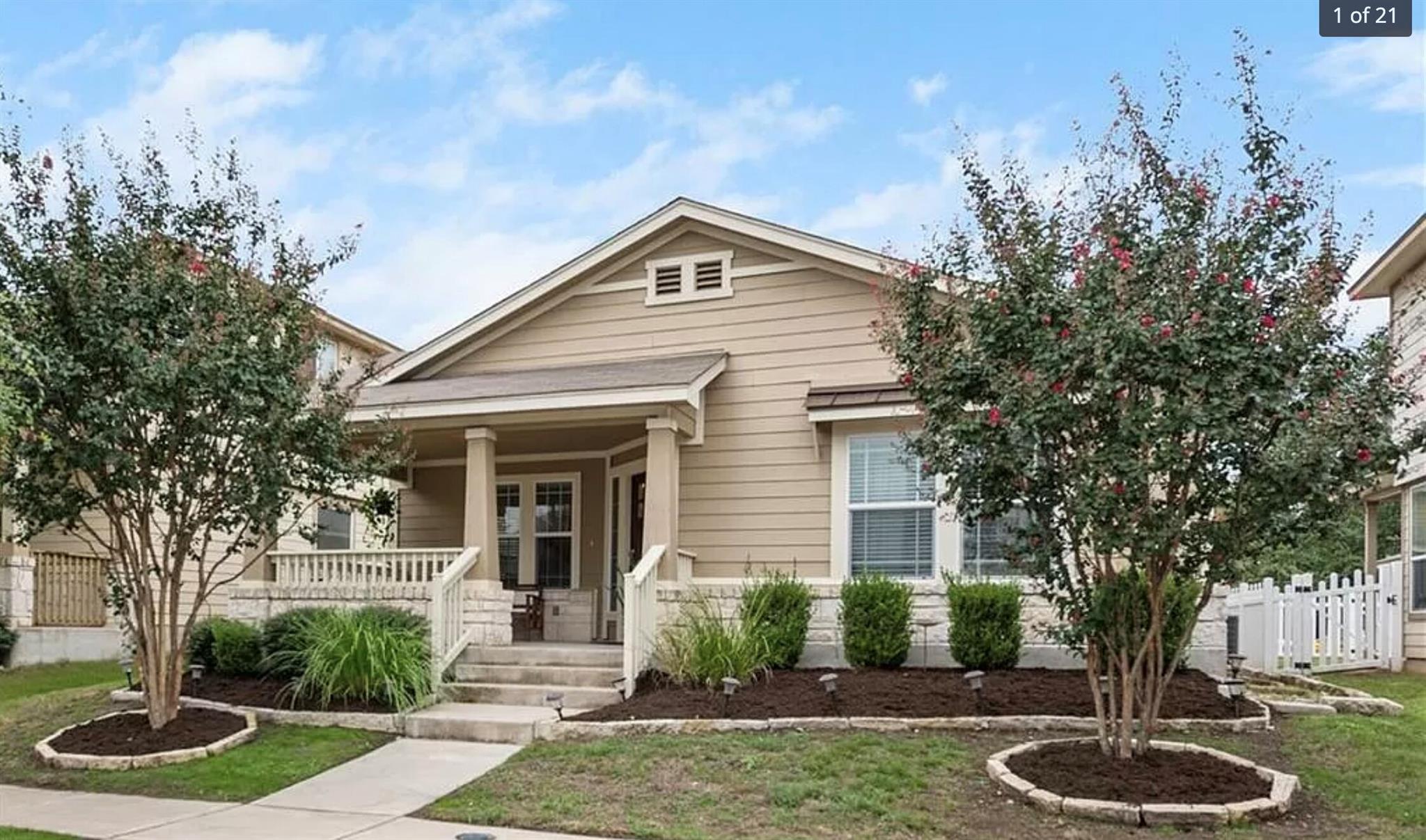 An inviting front porch and manicured landscaping