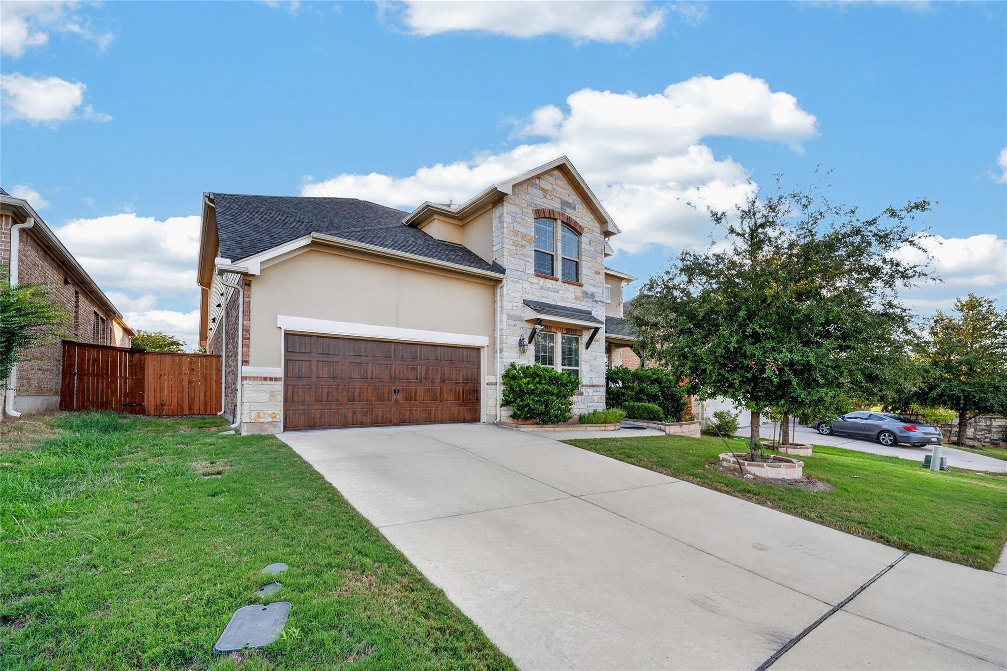 An attractive stone and stucco exterior features 