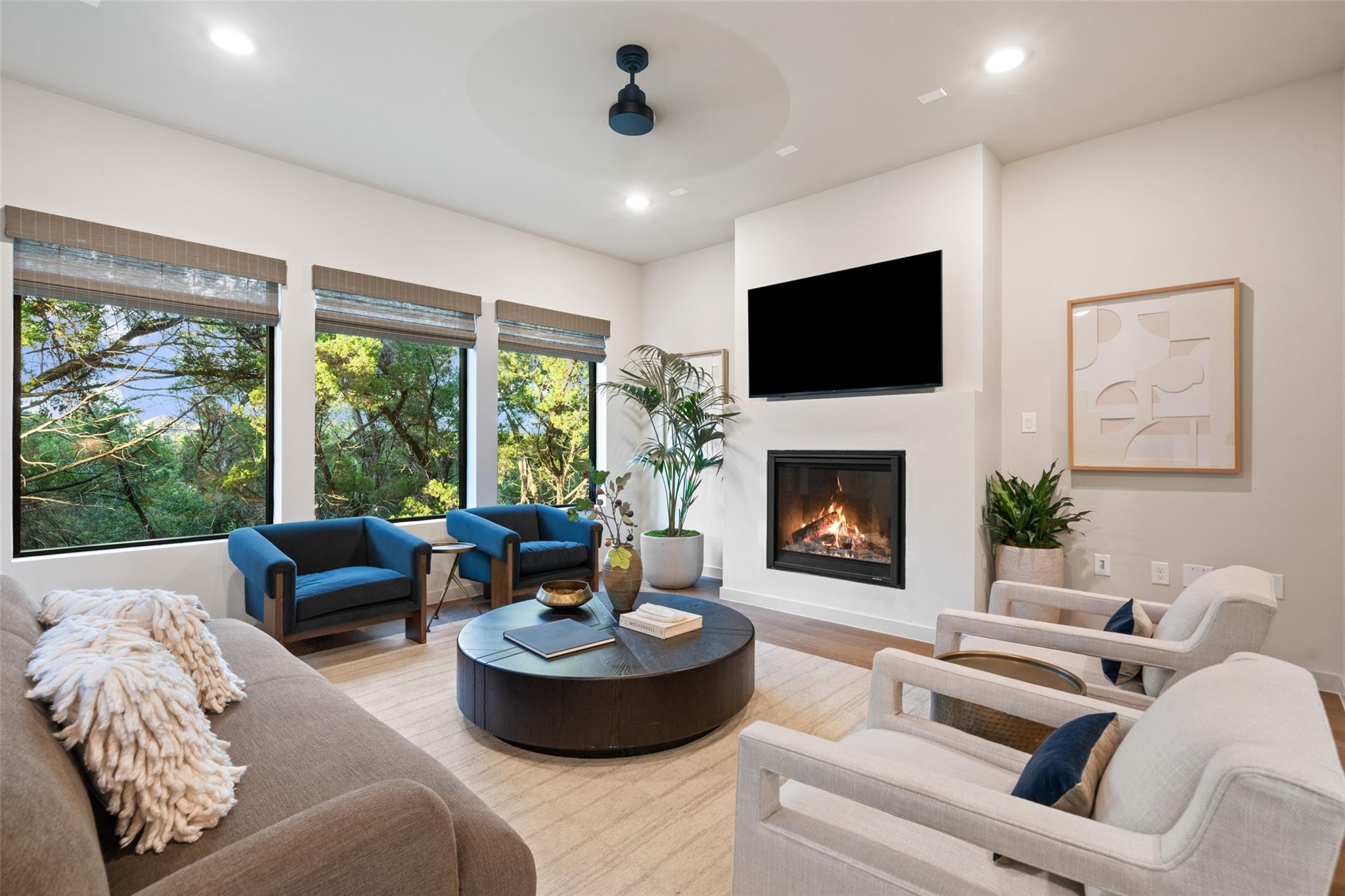 Large picture windows and a modern fireplace defi
