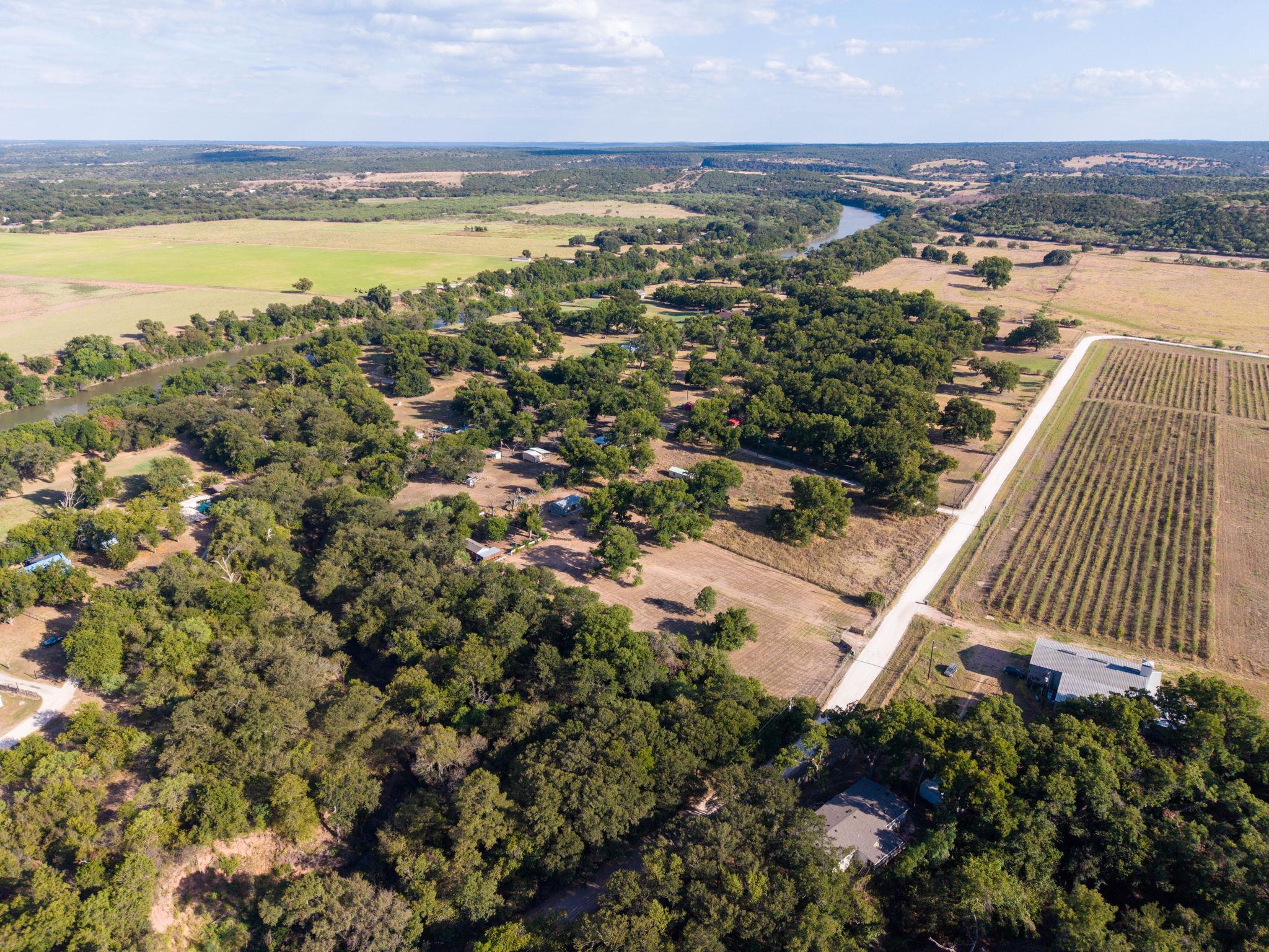 Mature trees and rolling acreage border a winding