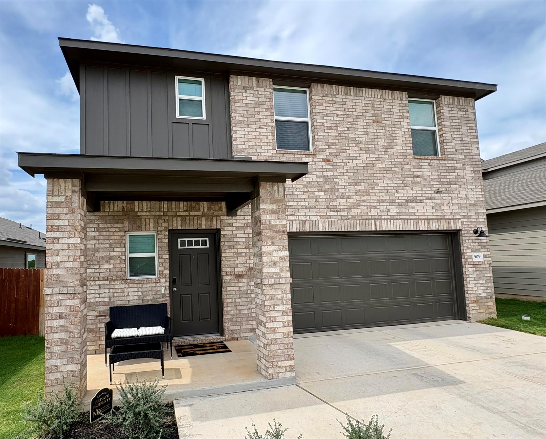 Textured brickwork accents the exterior of this t