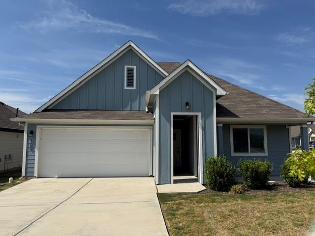 Gabled rooflines and a concrete driveway define t
