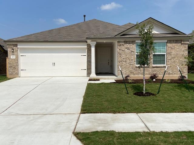 Brick veneer walls and a clean concrete driveway 