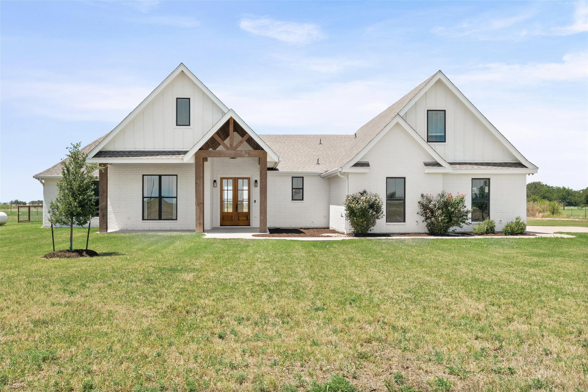 Crisp white brickwork and warm wooden gables crea