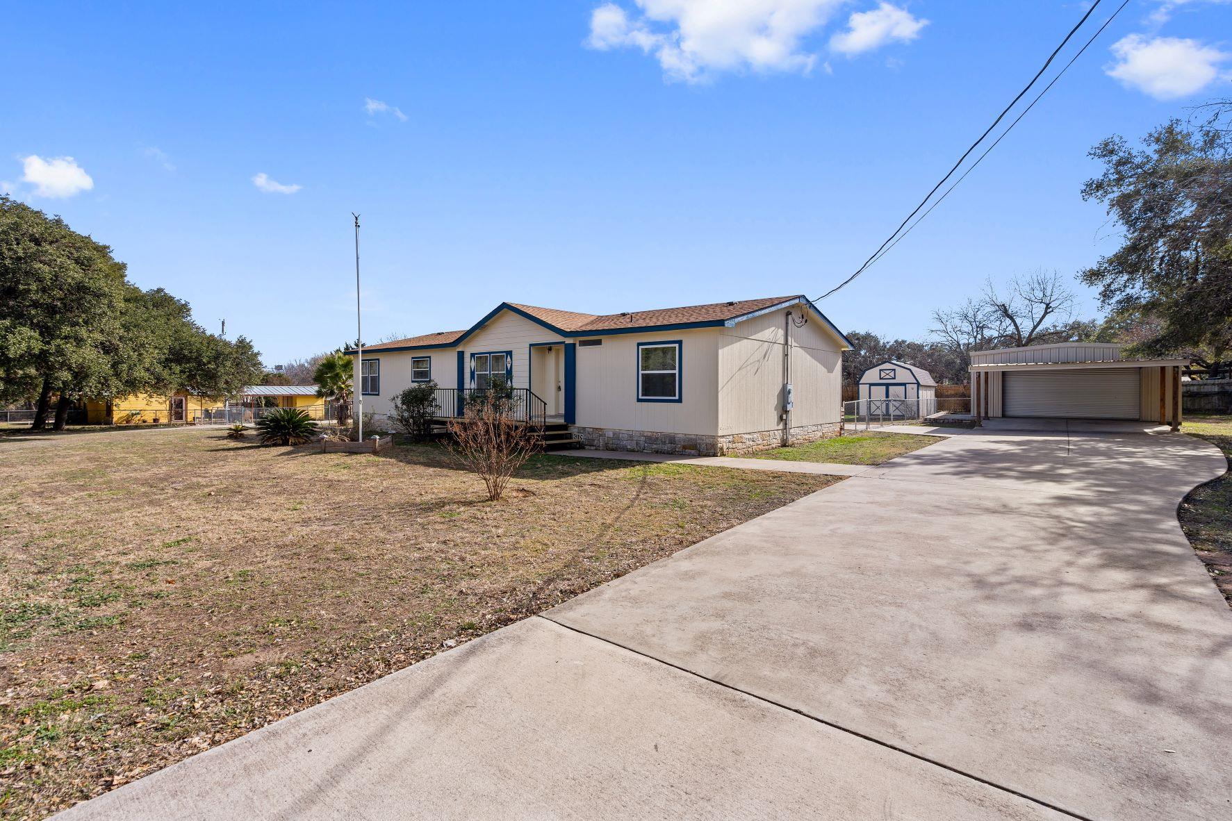 A long concrete driveway guides the eye toward th