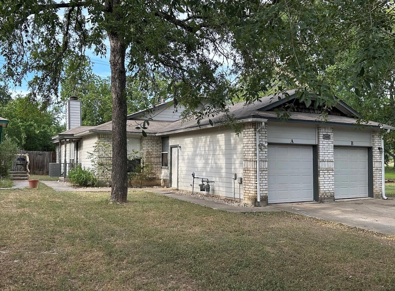 Mature trees shade the exterior of this multi-uni
