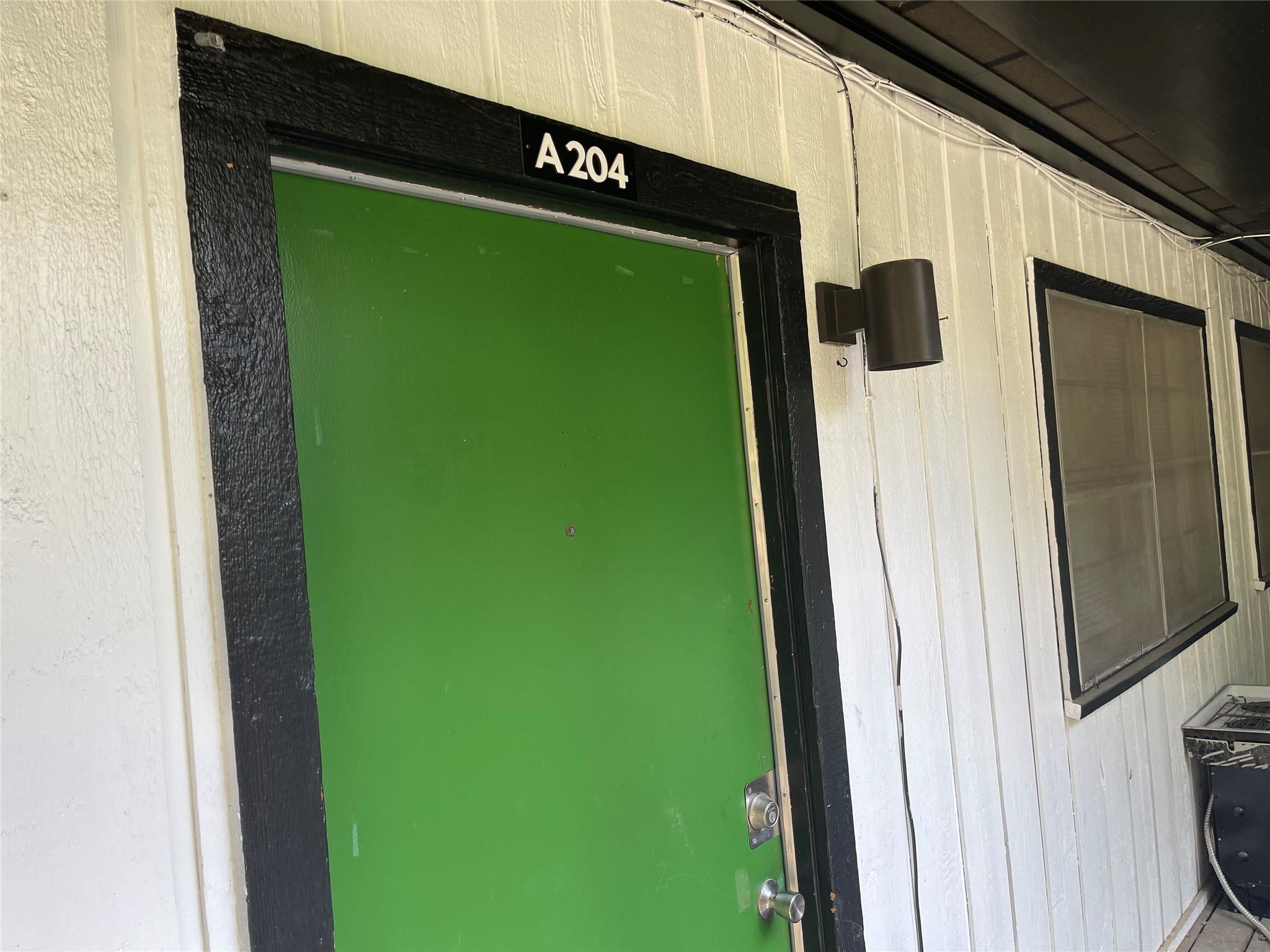 Board and batten siding frames the entry door of 