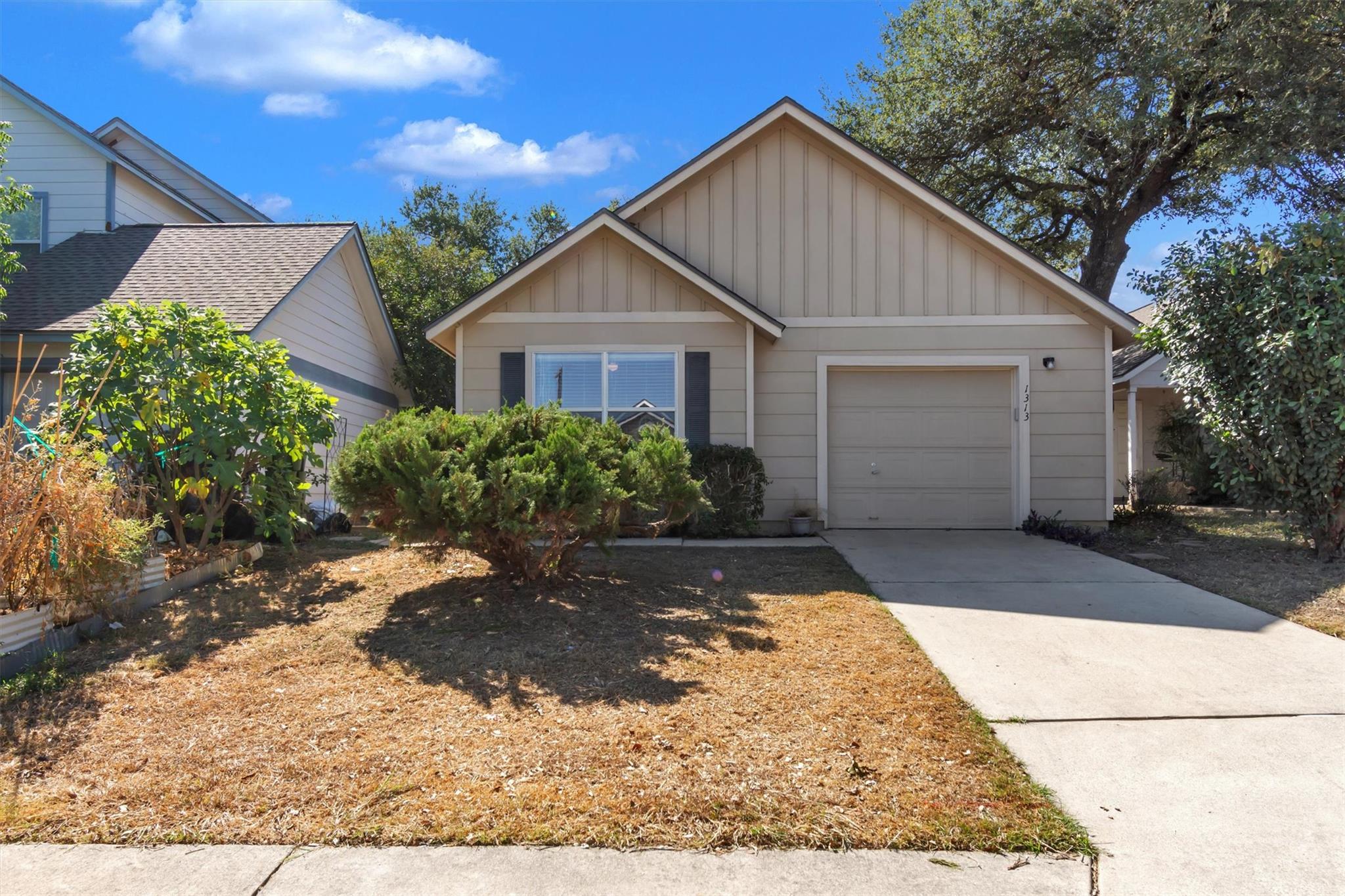 A concrete driveway leads to this classic suburba