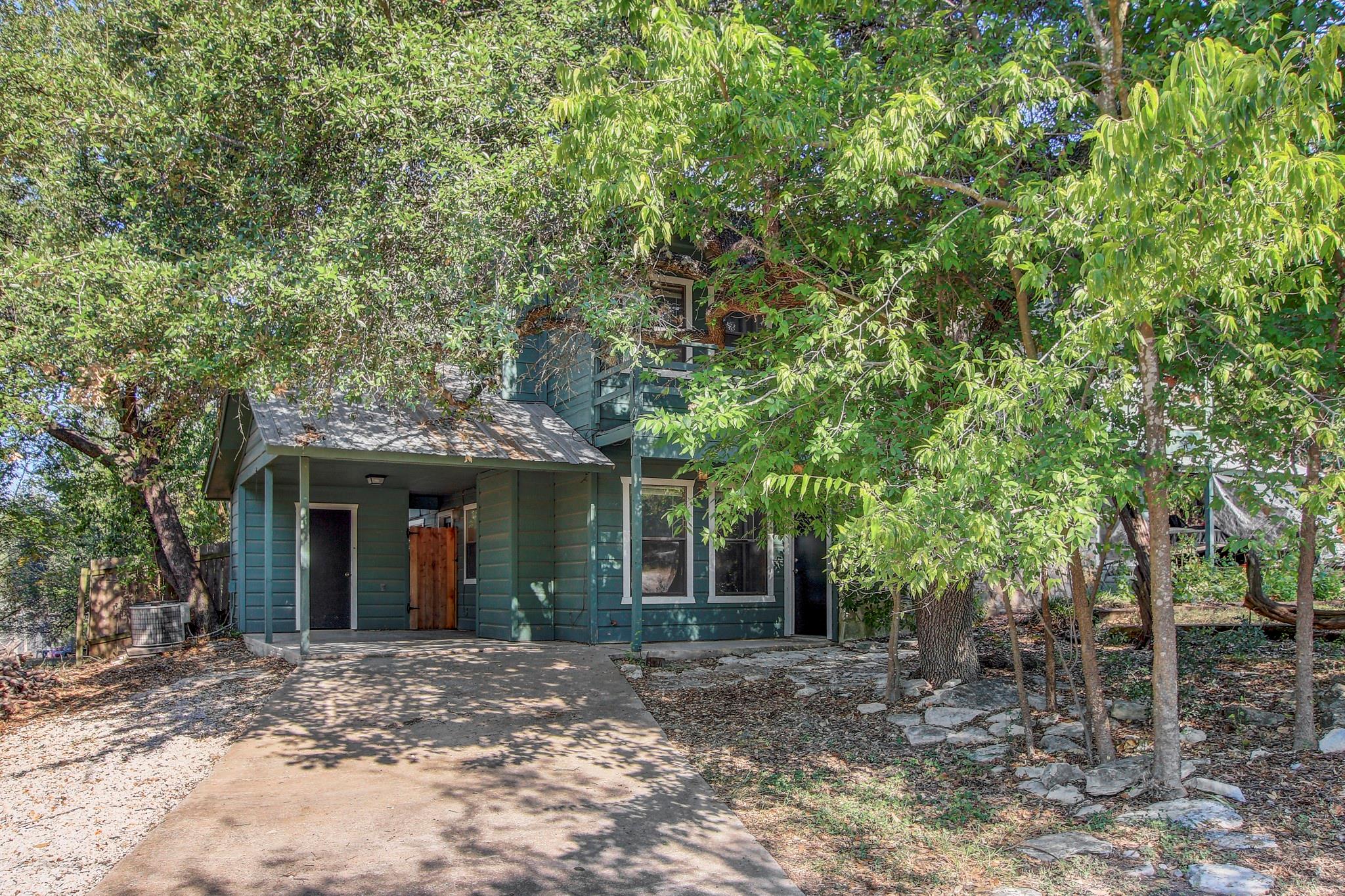 Mature trees shade a charming multi-level exterio