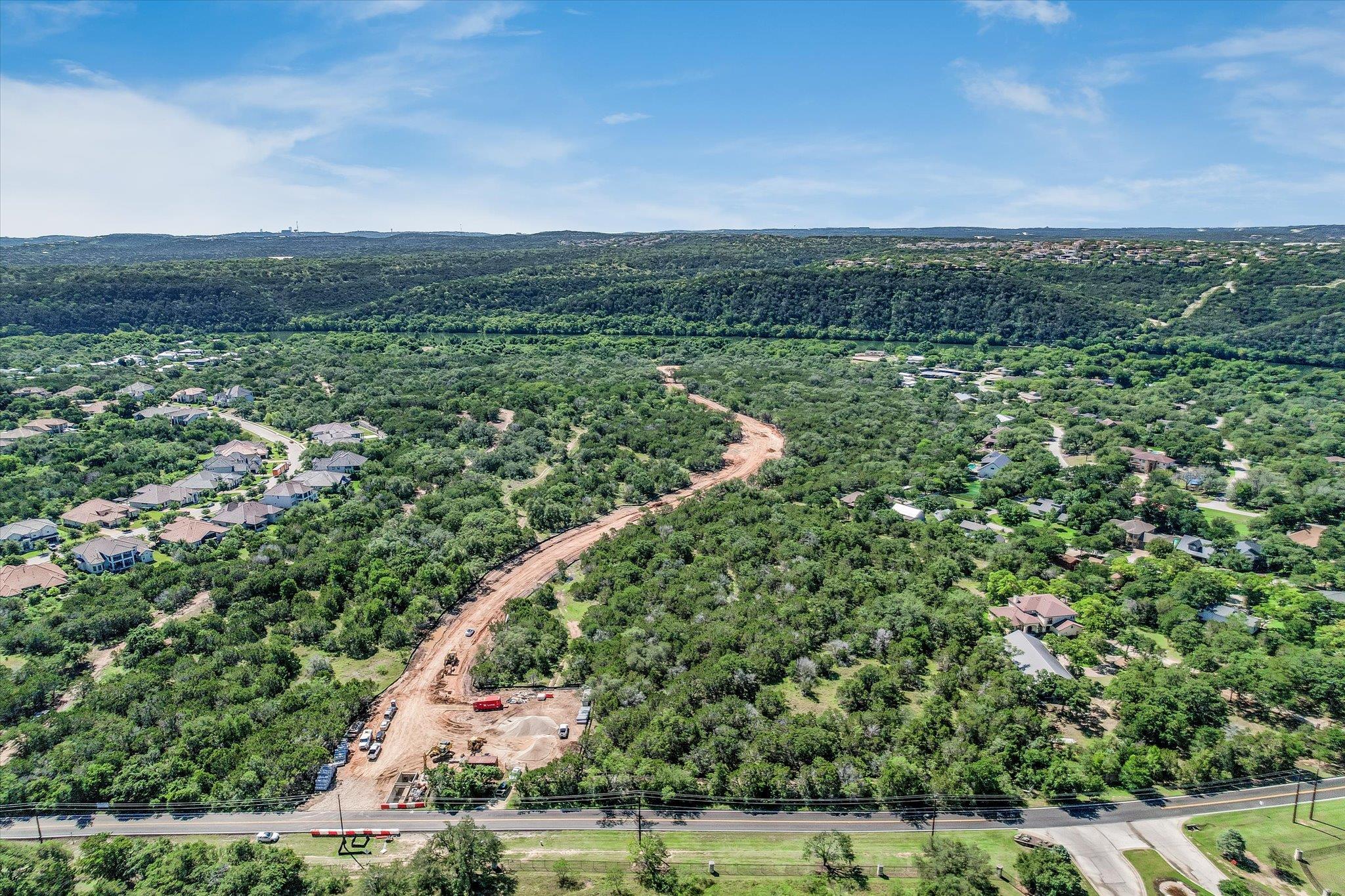 Lush rolling hills frame a sprawling neighborhood