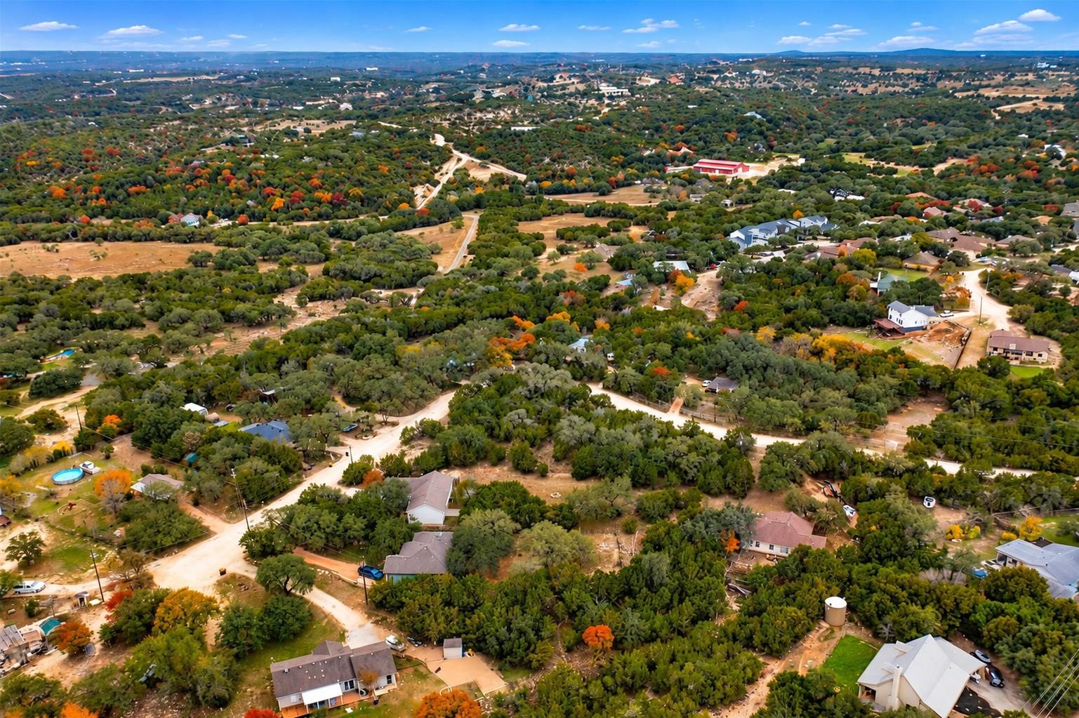 Mature trees and rolling hills surround this neig