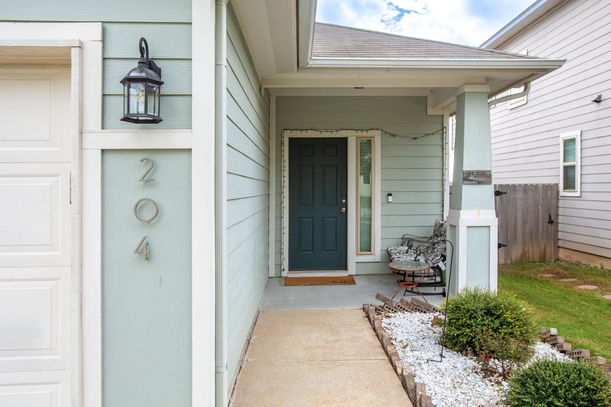 An inviting covered front porch with a concrete w