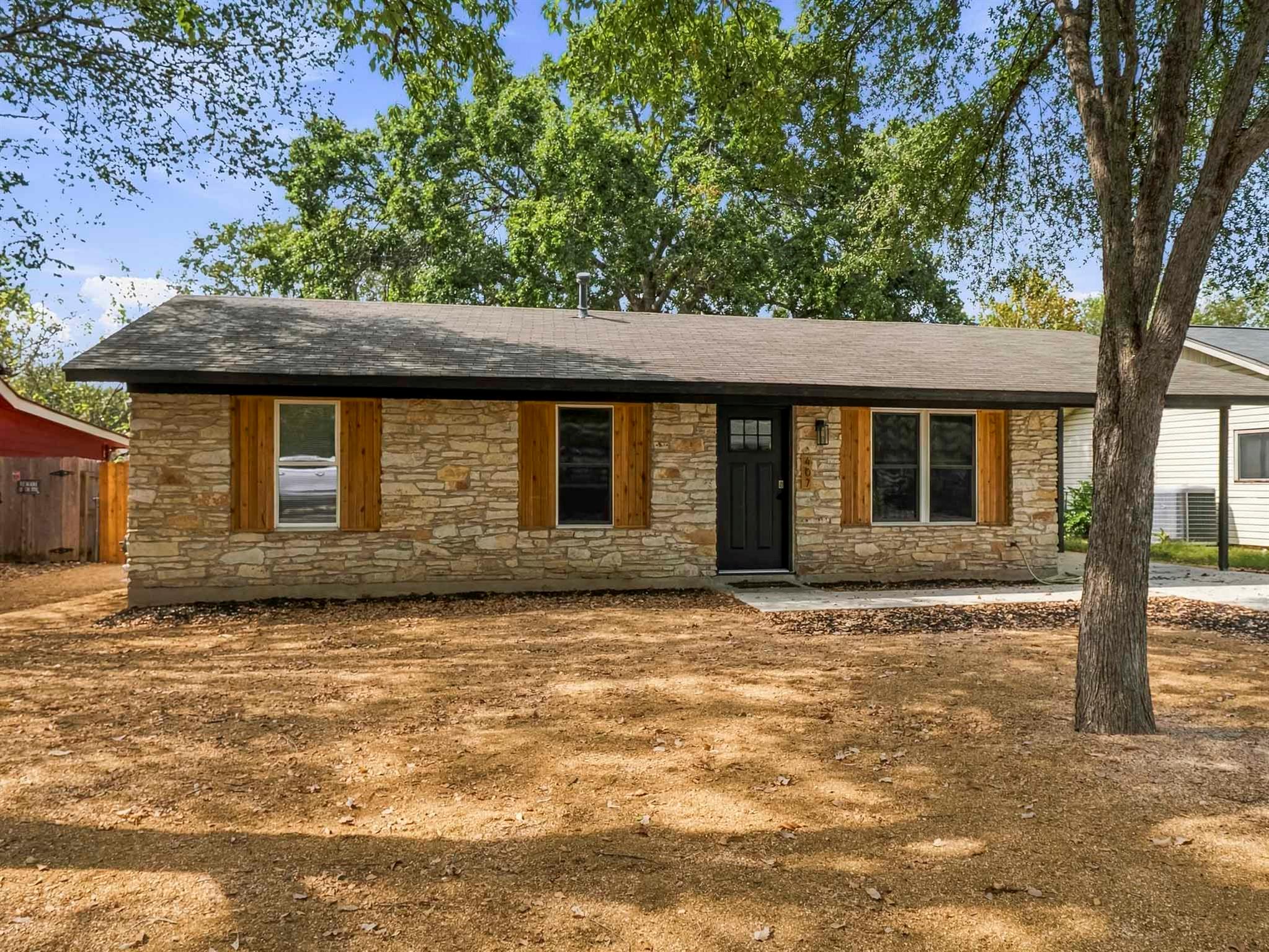 Natural stone masonry and warm wood shutters crea