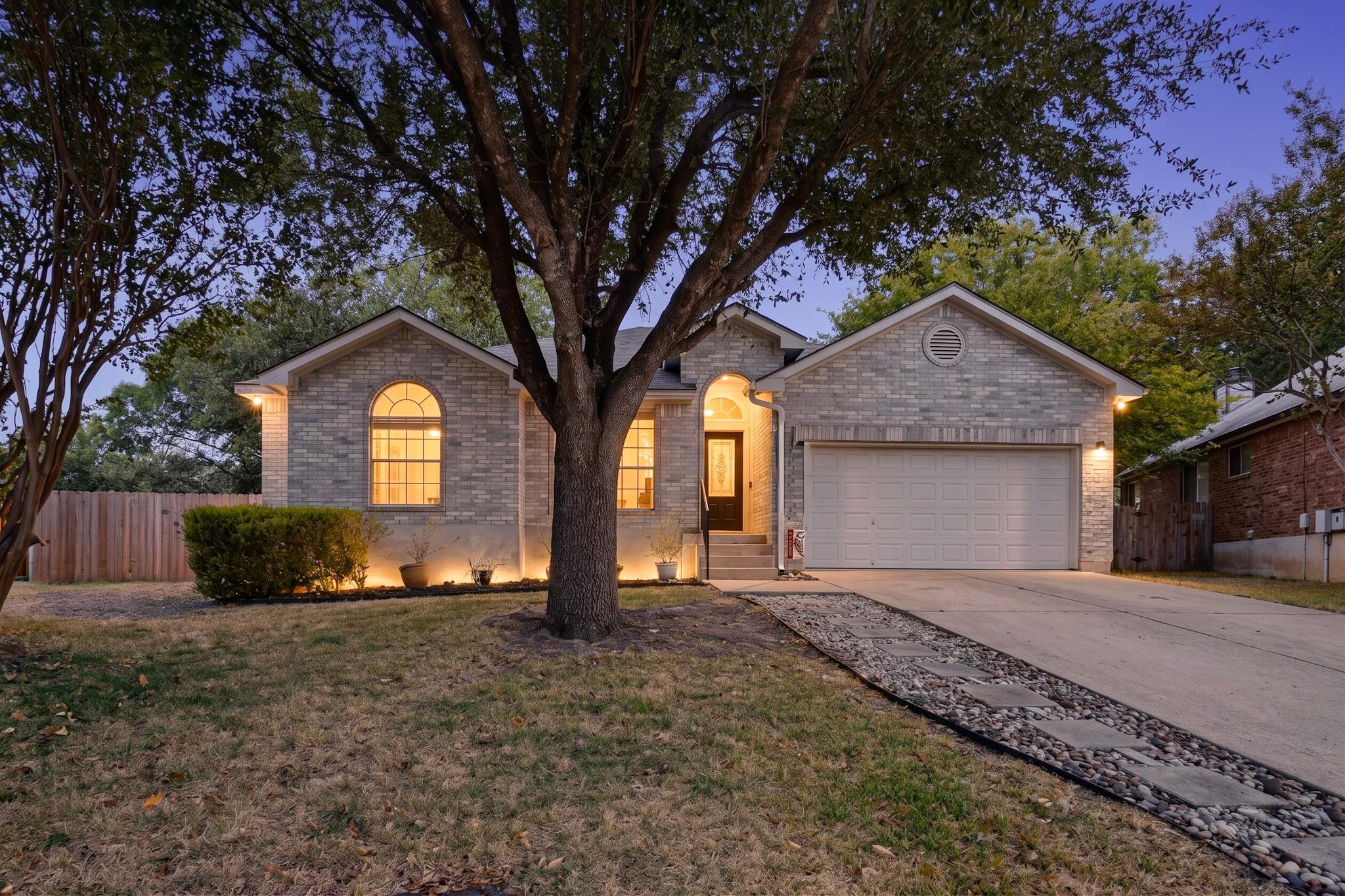 A classic brick exterior stands framed by mature 