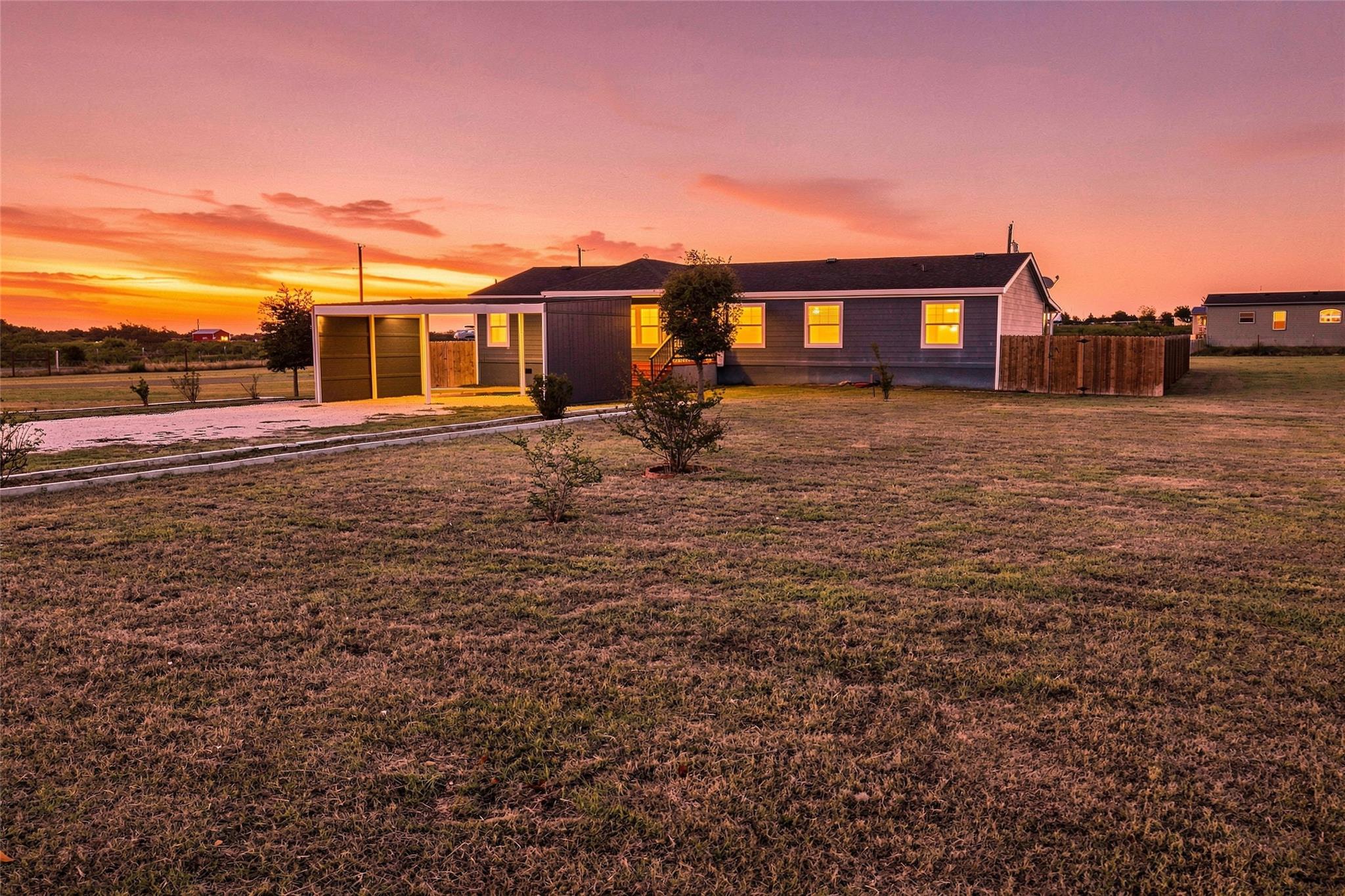 An expansive grassy lawn surrounds this modern si