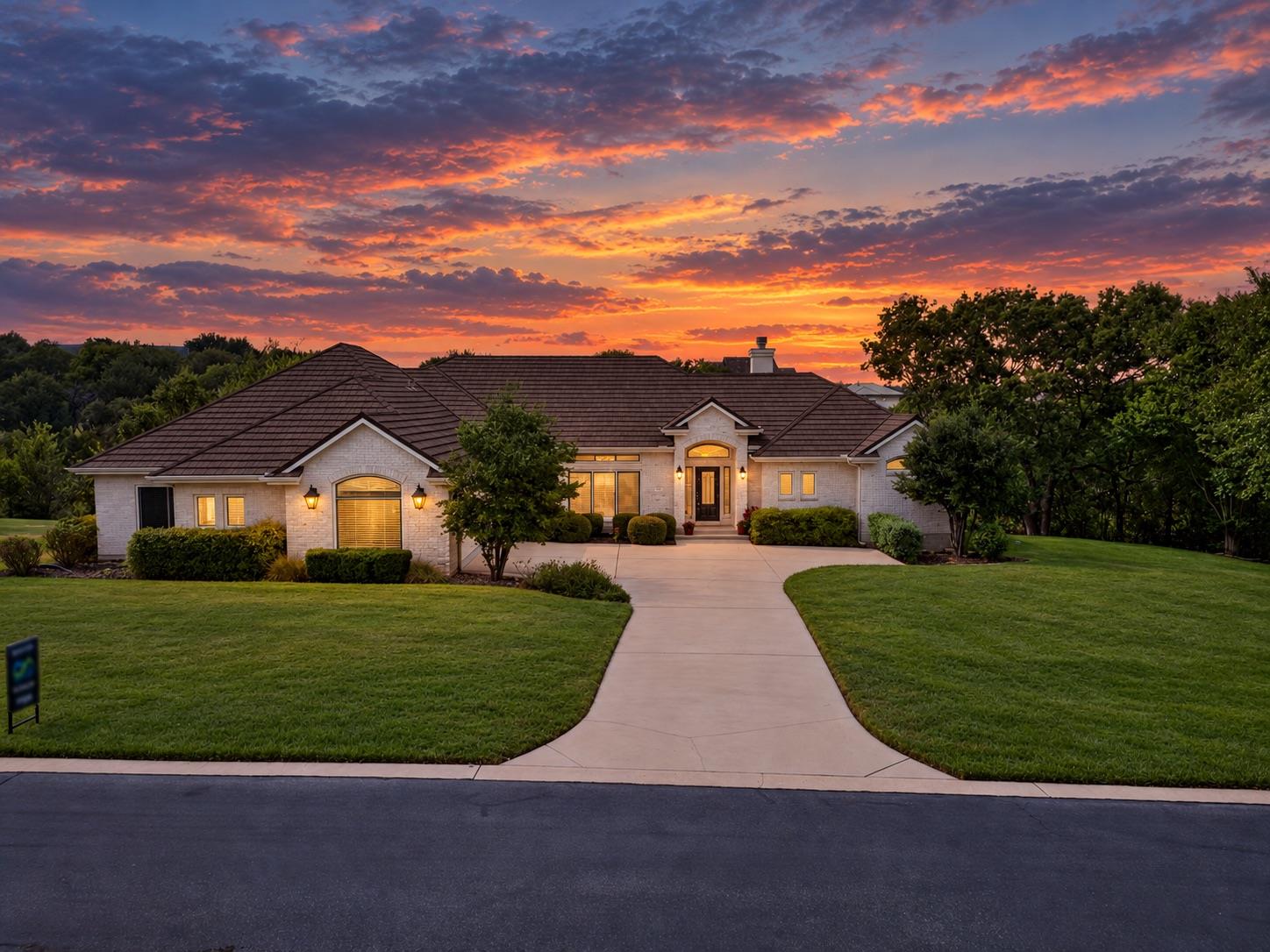 Manicured lawns and a spacious concrete driveway 