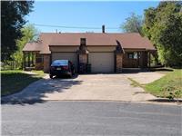 A classic brick exterior, double garage, and cove
