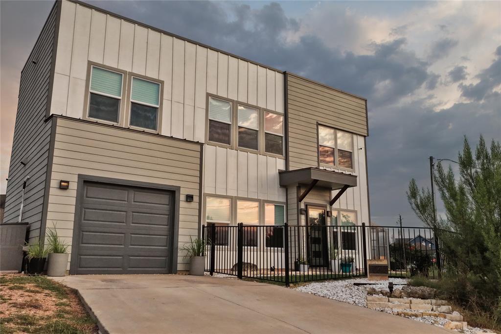 A concrete driveway leads to this contemporary tw
