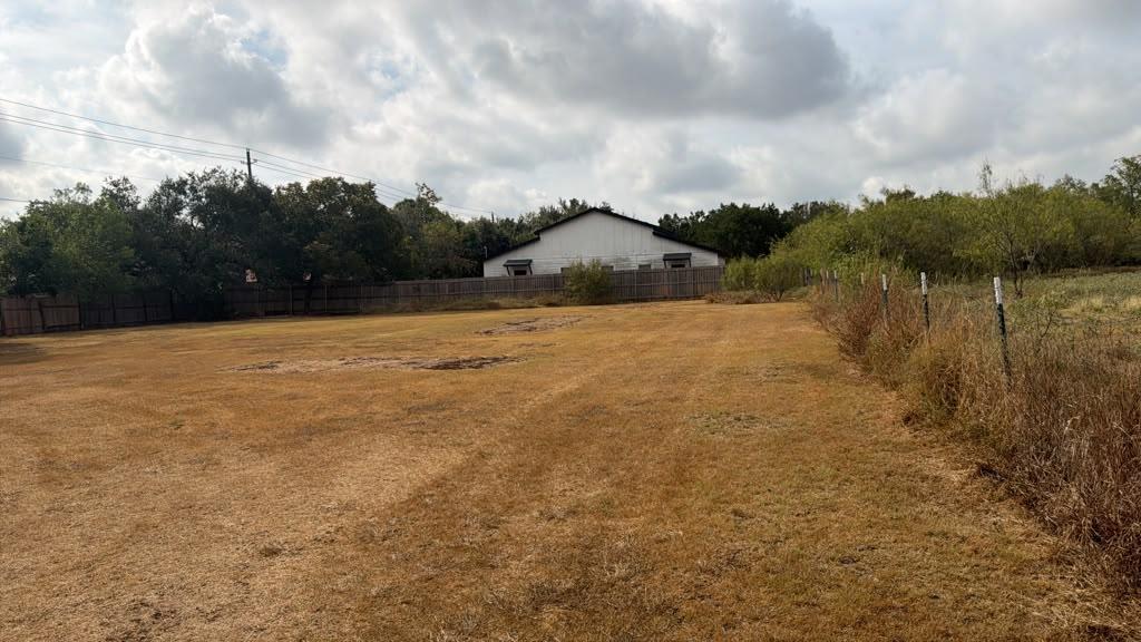 An expansive level lot is fully enclosed by fenci