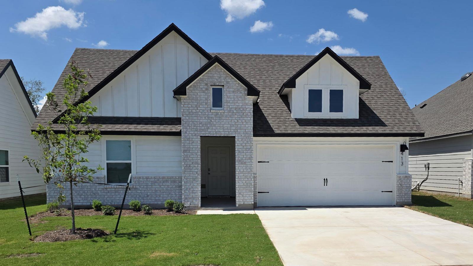 A classic brick and siding exterior stands out ag