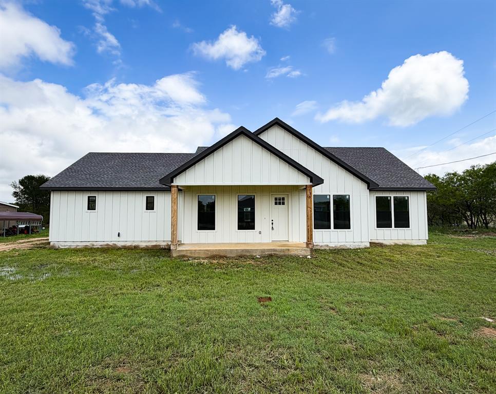 Crisp vertical siding paired with dark trim defin