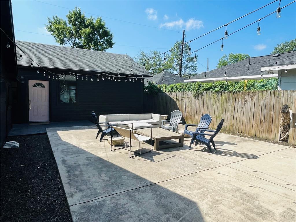 An expansive concrete patio provides a versatile 