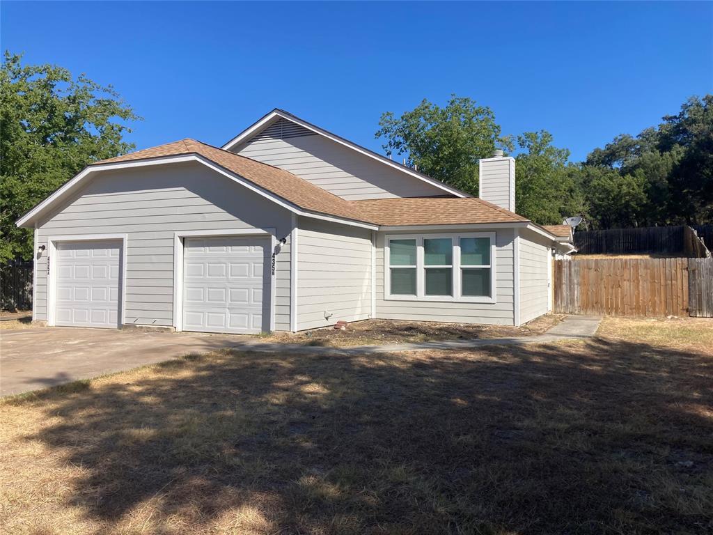 A spacious driveway leads to this modern multi-le
