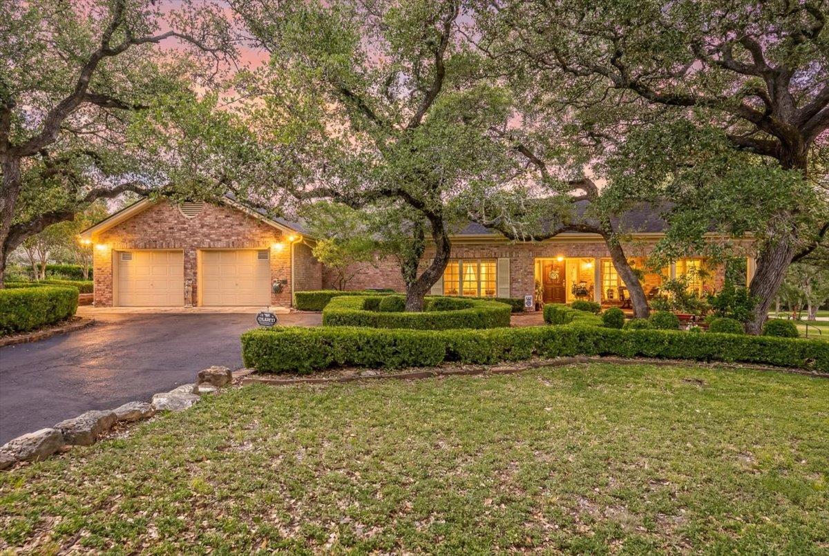 Mature oak trees and structured manicured hedges 