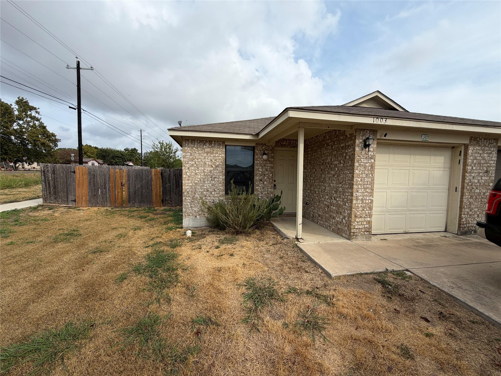 Brick exterior walls and an attached garage defin