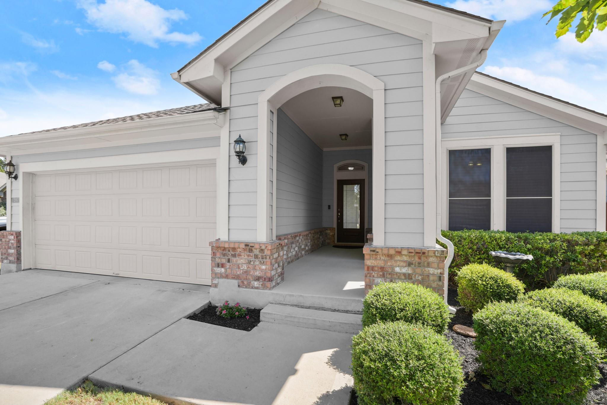 A welcoming arched entryway leads to the front do