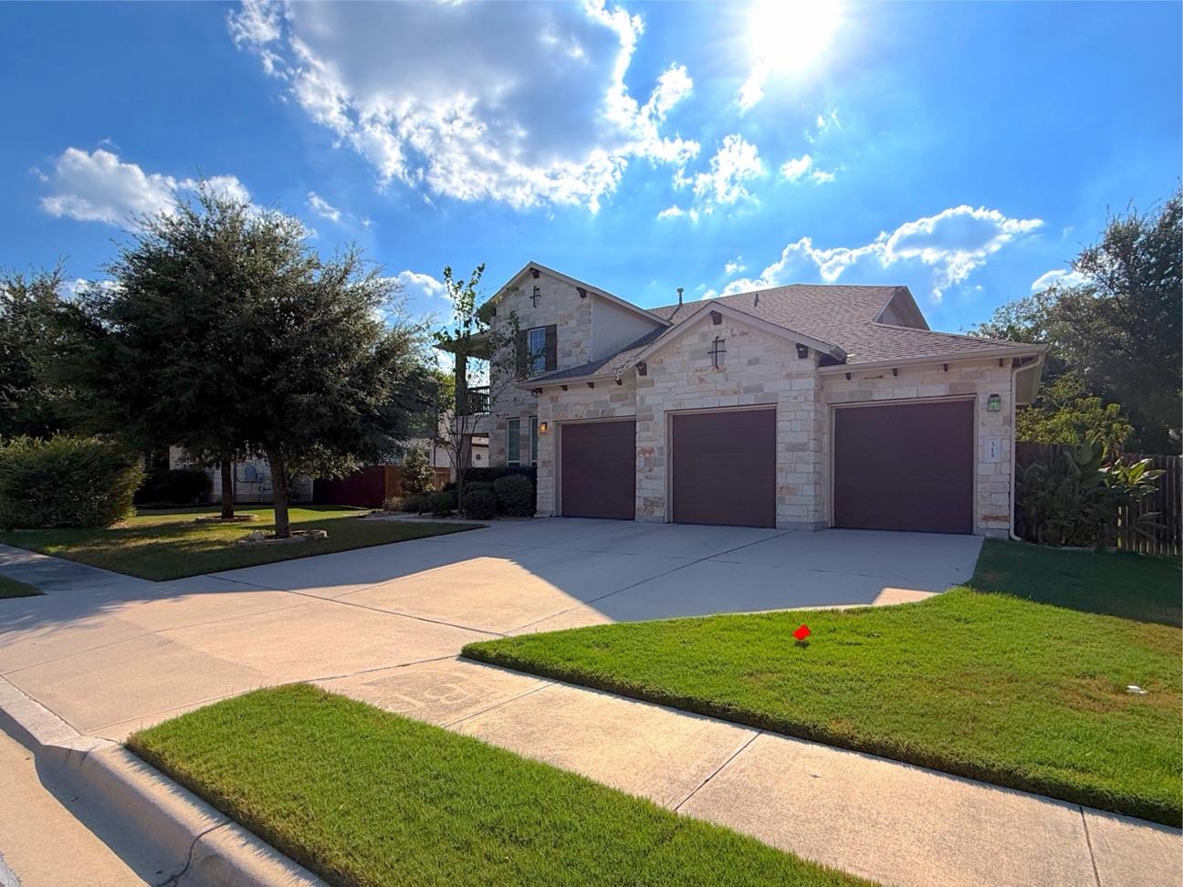 A spacious driveway leads to this stone home with